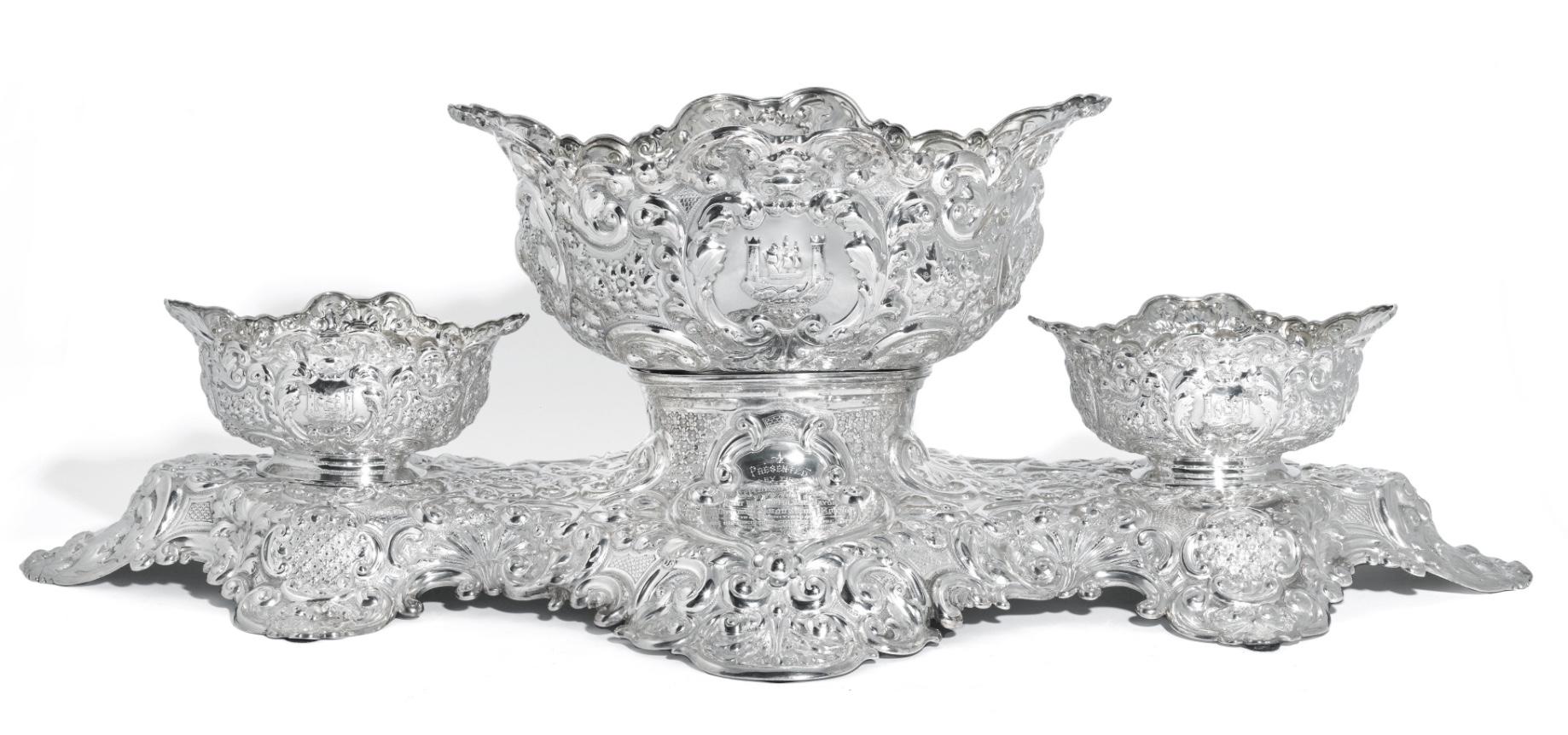Large and highly decorative, antique Victorian, sterling silver, centerpiece made by Horace Woodward & Co, London 1894. The embossed plateau of bold scrolling shell and foliate ground around two central cartouches, one engraved with presentation