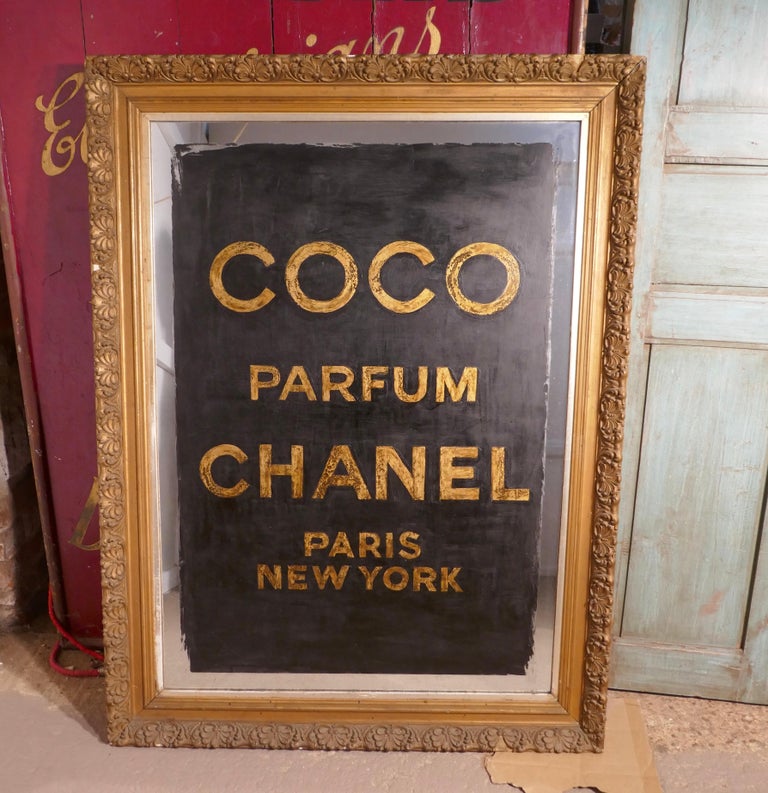 Large decorative Art Deco advertising mirror

A very pretty piece, this is an Art Deco mirror, the mirror frame is 4” wide and painted in Black and Gold advertising COCO CHANEL perfume, this is a very decorative piece (probably Painted in recent