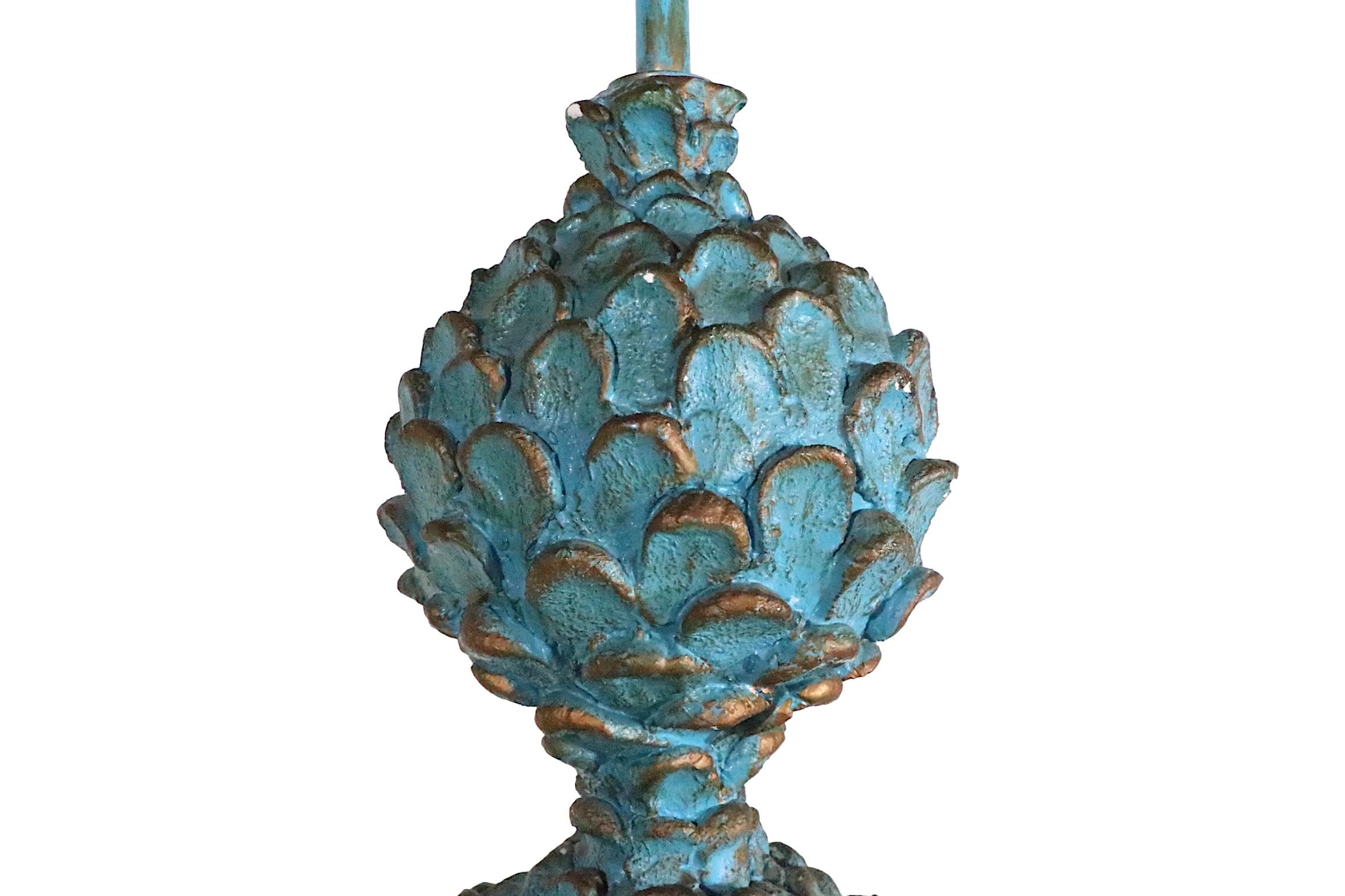 Decorative table lamp composed of painted plaster depicting a fantasy version of a potted  plant, in turquoise with gold highlights paint finish. Large, impressive scale, chic voguish style  Hollywood Regency style, table lamp circa 1970's.
The lamp
