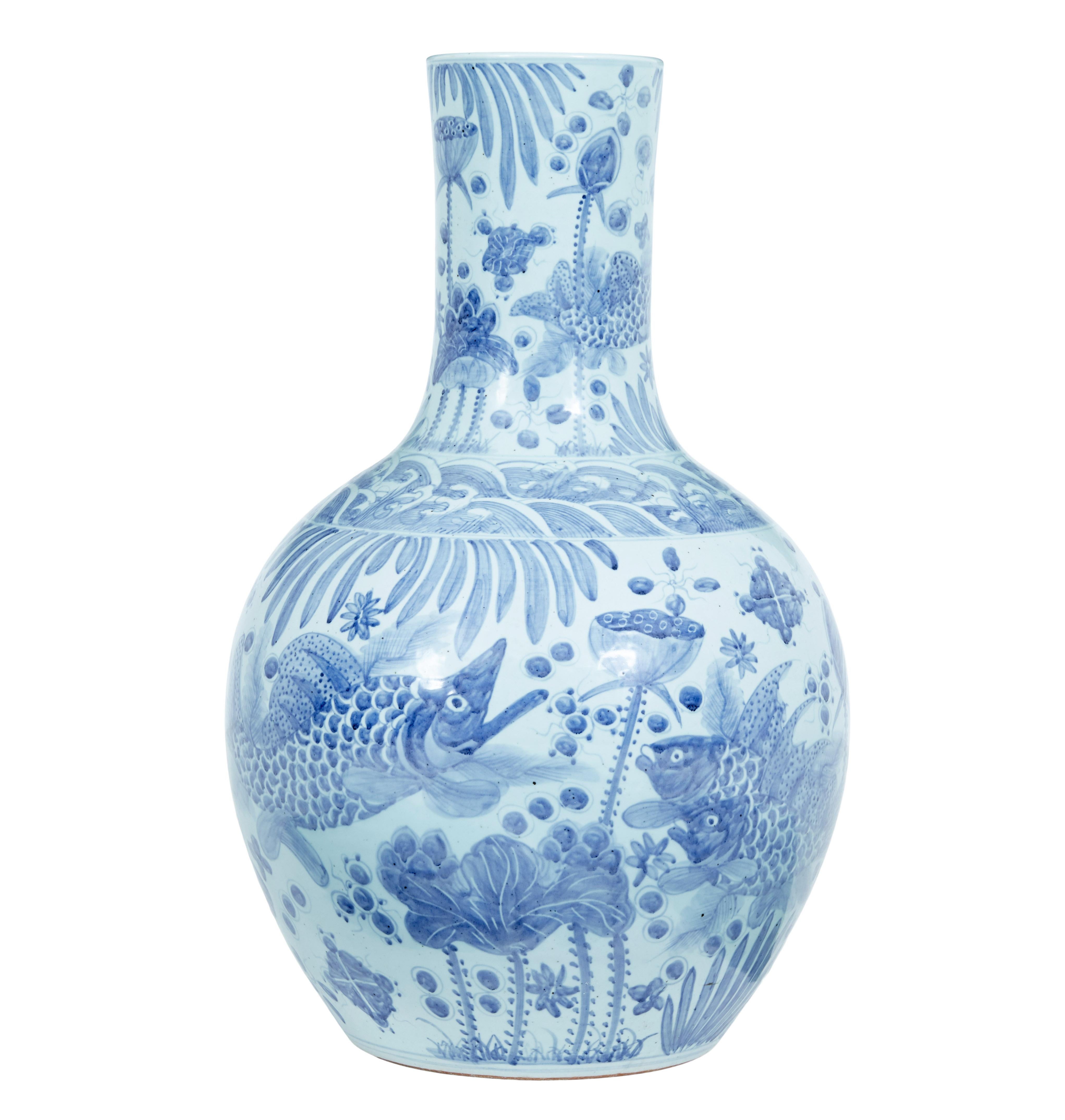 Large decorative blue and white ceramic chinese vase circa 1980.

Oversized bulbous vase, hand painted, depicting fish, poppies and florals. Ideal for any room in the house, or even in the garden.