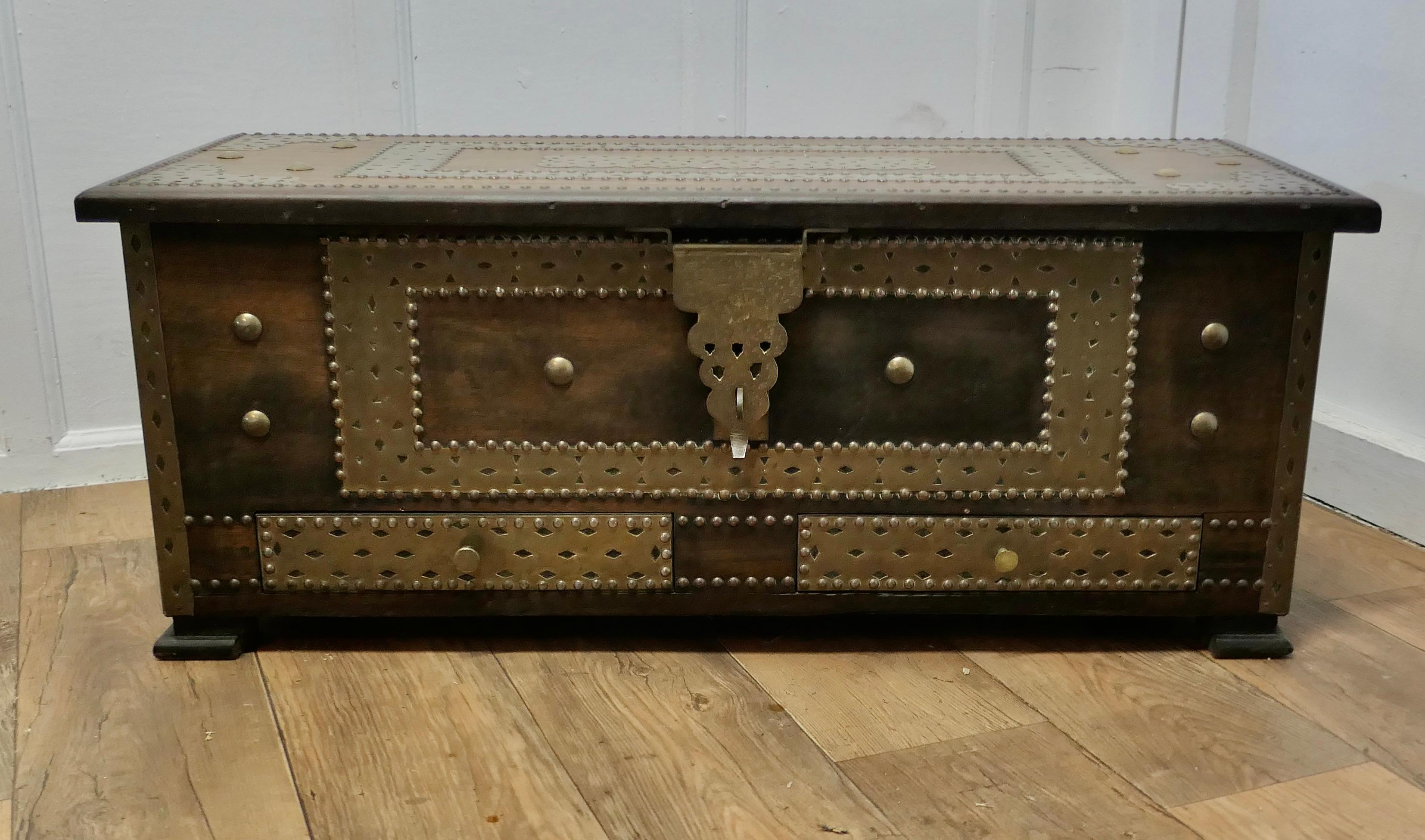 Large Decorative Brass Zanzibar Trunk with Drawers

This chest is in fact a mule Chest as it has 2 drawers at the bottom decorated with brass studs and fretwork and the brass hasp can be secured by adding you own clasp
Chests like this were often