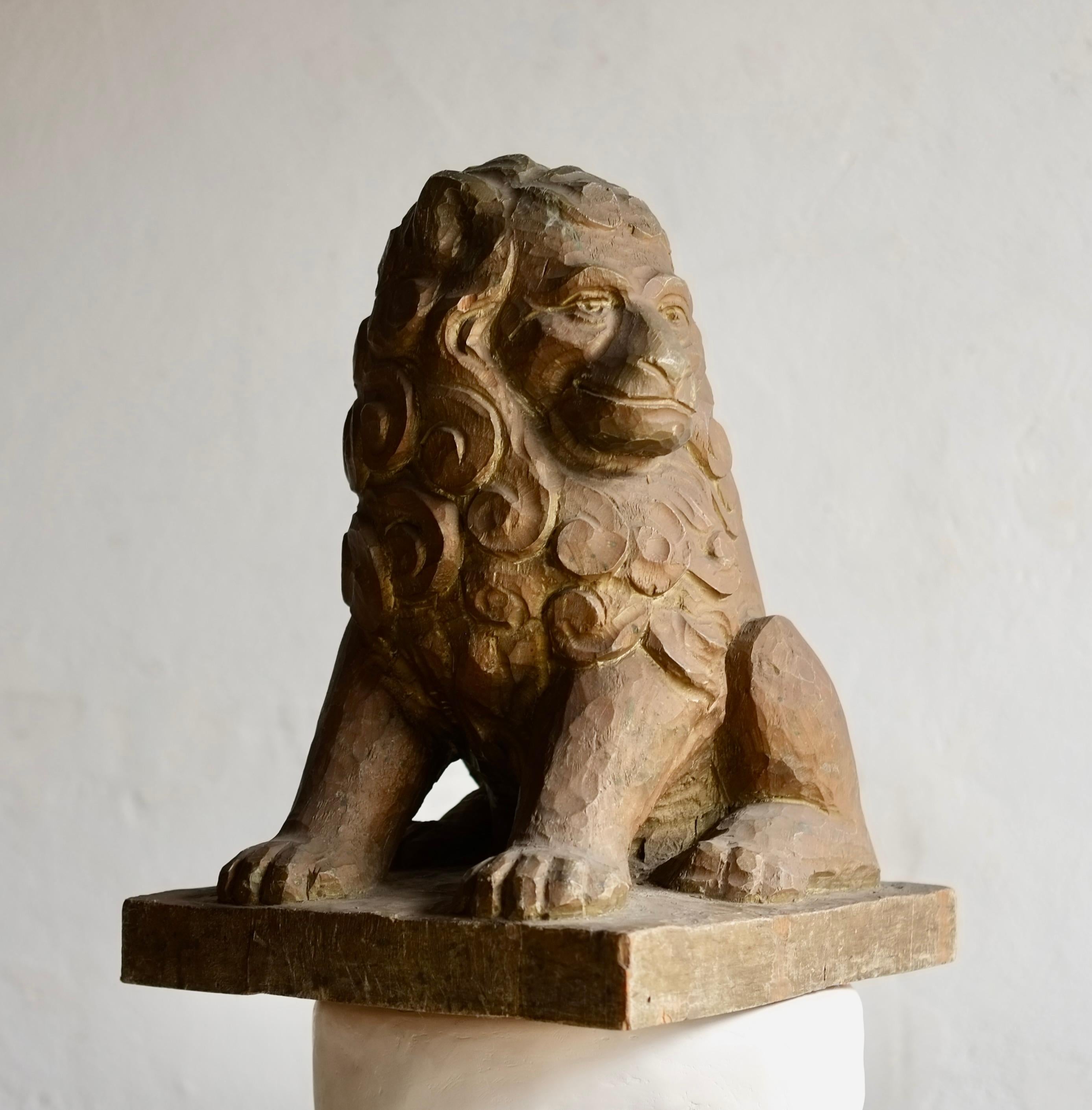 An artisanal hand carved wooden lion sculpture believed to be German from the early 20th Century. 

Impressive large scale, heavy in weight and featuring excellent craftsmanship with beautifully detailed curls to the lions mane. Traces of worn gold