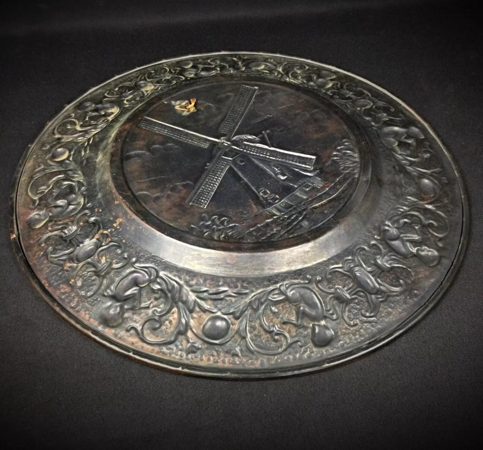 This large copper plate features a charming windmill design and is perfect for hanging as a decorative piece. Its detailed craftsmanship reflects traditional French artistry. The plate is in good condition with minor signs of wear, making it a