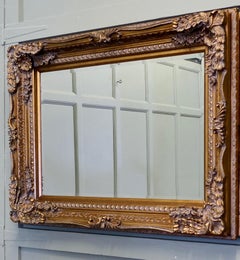 Large Decorative Gilt Wall Mirror  This is a lovely old bevelled mirror