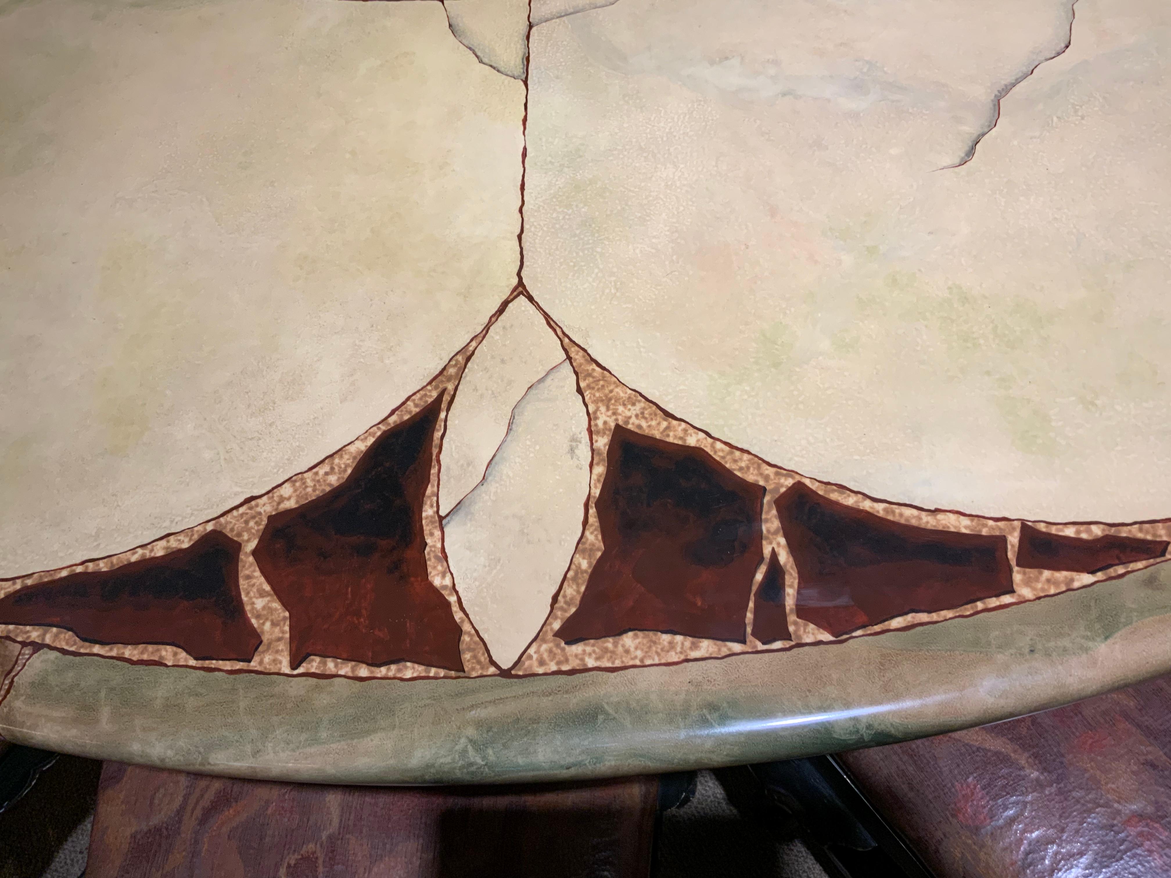 This table is made of wood with a laminated surface with a highly 
Decorative design in shades of cream green and copper colors
It has a glossy finish and is in exceptional Condition. It is 96” in diameter 
And seats 12 people easily. It sits on