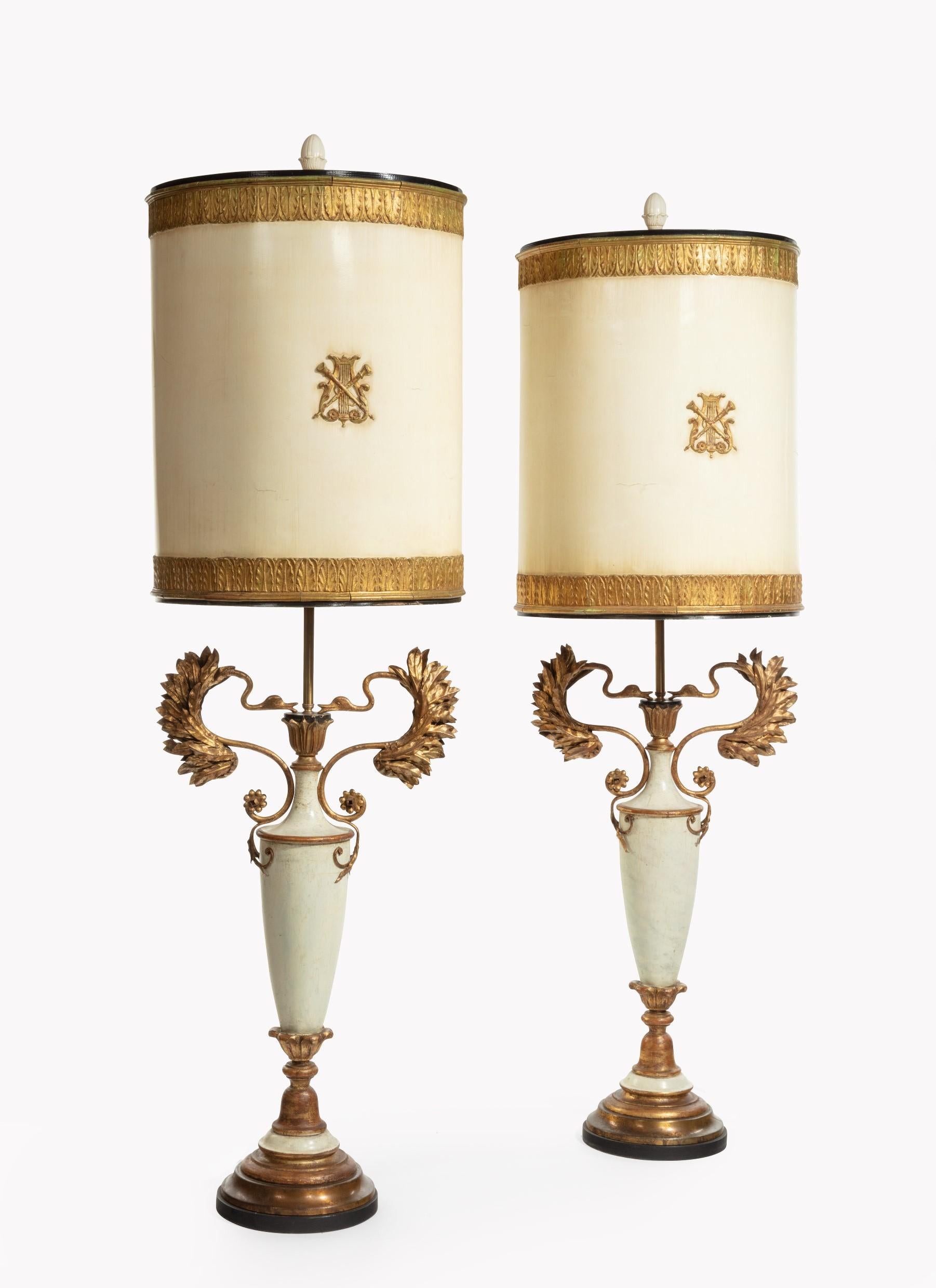 A fantastic and decorative very large pair of original painted and gilt French floor lamps. 

Of classical design these rare pair of French lamps measuring 1.5 meters in height retain their original painted and gilt shades having embossed gilt