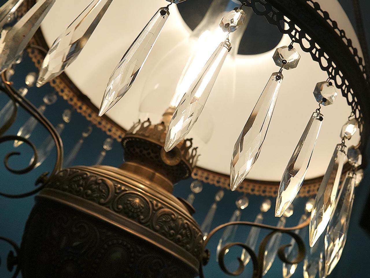 This is a beautiful Victorian oil lamp that we recently converted to electric. It has a perfect mat finish milk glass dome shade and tons of decorative detail. Including stamped brass decoration, brass castings and scroll work. There is also a ring