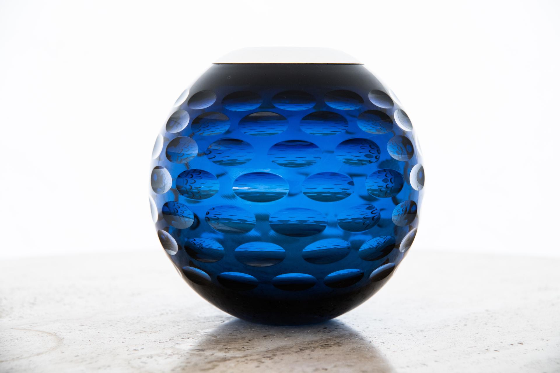 Large modern mouth-blown crystal match strike in deep blue color decorated with cut oval spheres. A single sphere on the strike is cut in a crosshatch pattern and etched to provide a friction spot on which to strike the match. The sterling silver