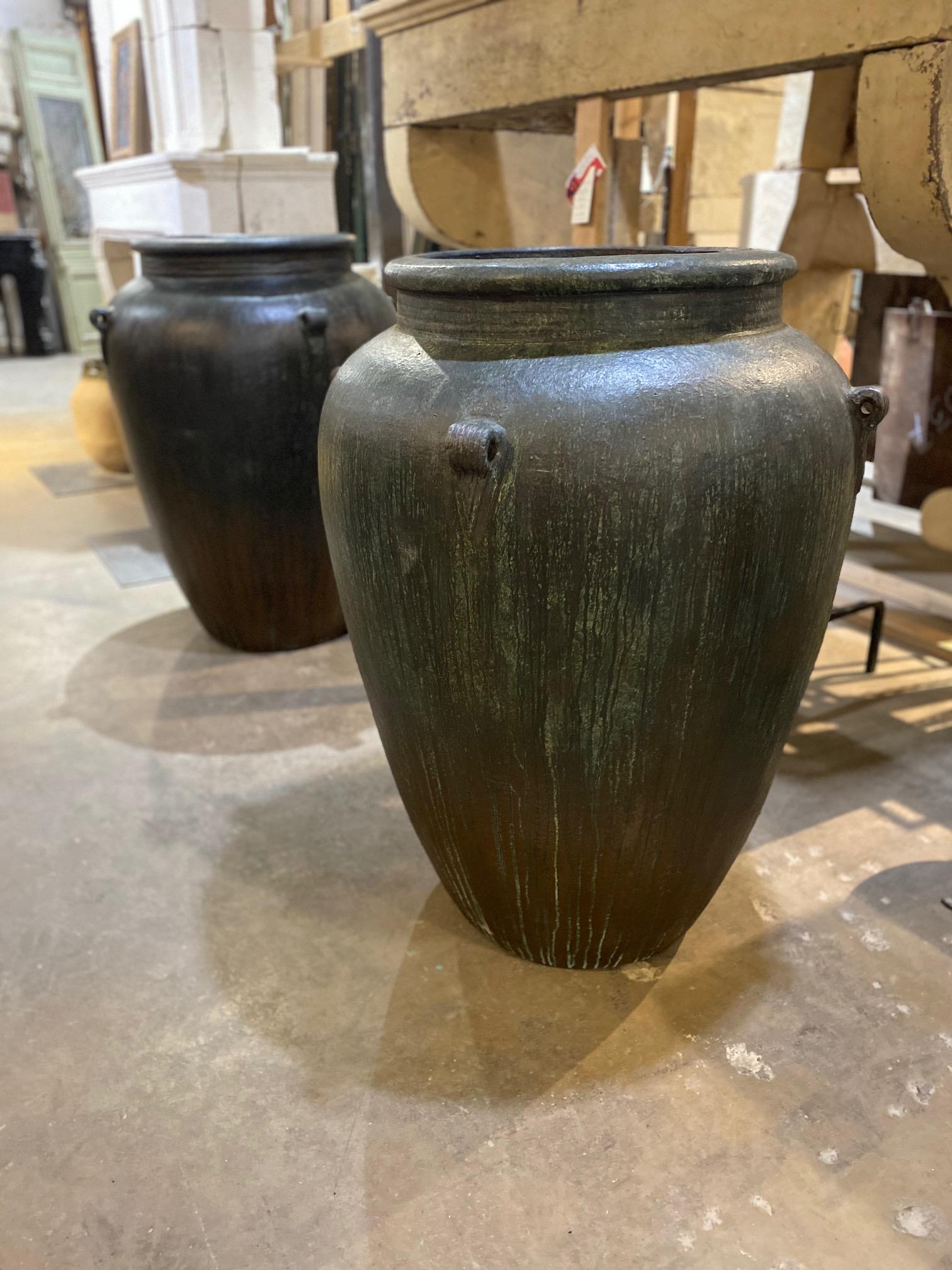 This midcentury vessel is painted in deep blue, bronze, and green for a unique exterior that will turn heads.

Measurements: 33” D x 43” H.