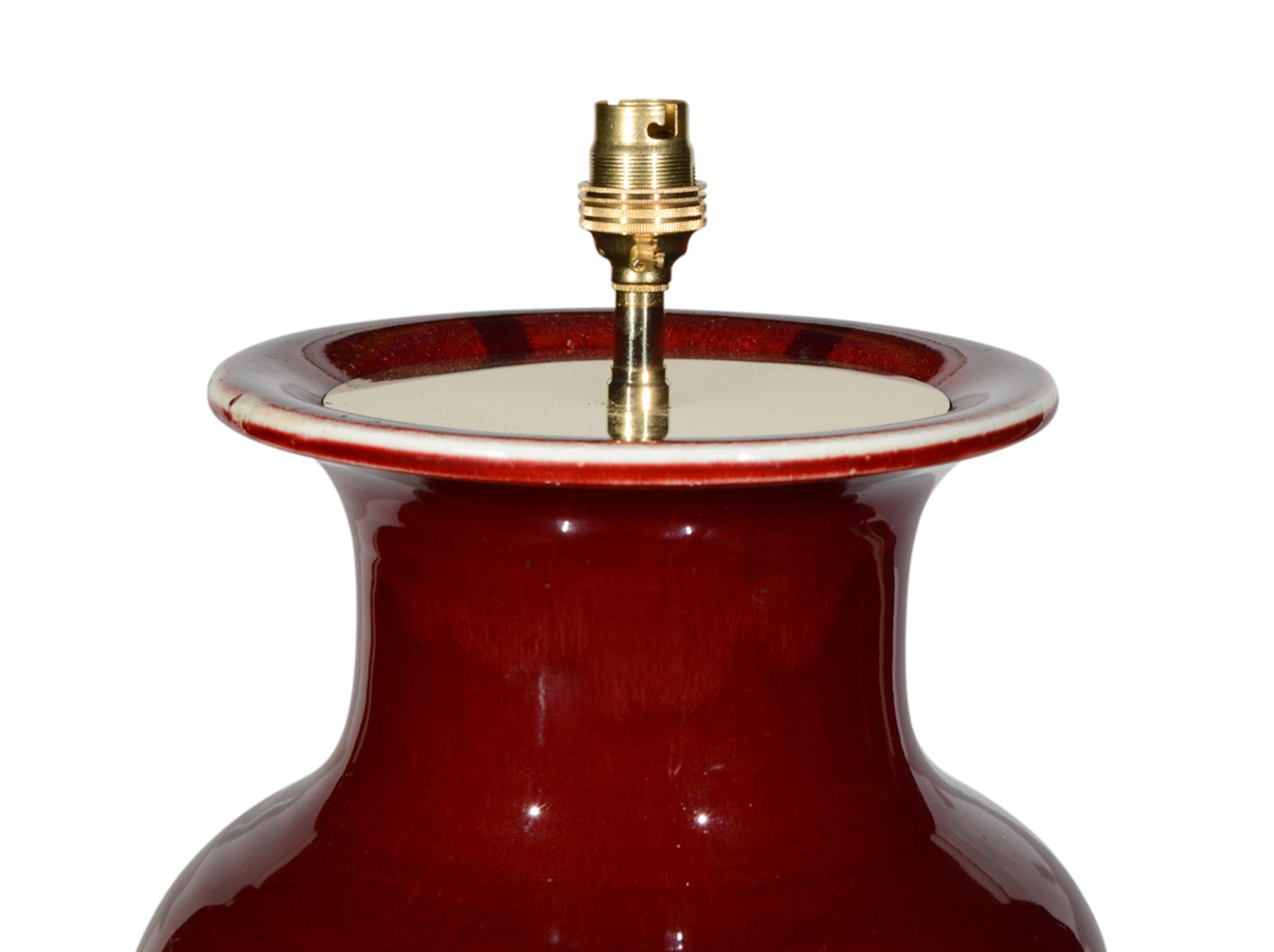 A superb large Chinese baluster sang de boeuf vase, with wonderful depth of glaze, now mounted as a lamp with a hand gilded turned base.

Height of vase: 23 1/4 in (60 cm) including giltwood base, excluding electrical fitment and lampshade

All of