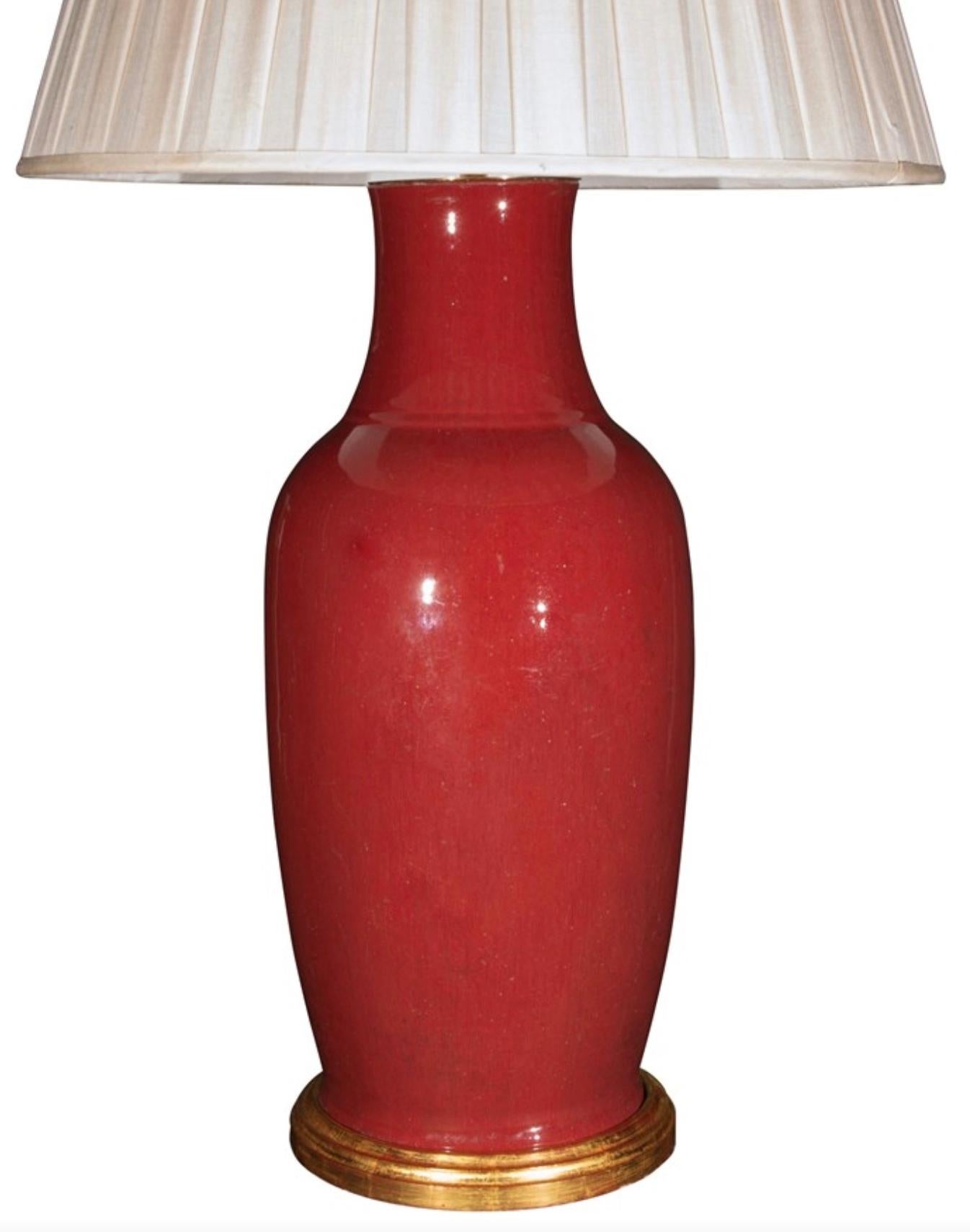 A fine Chinese sang de boeuf porcelain vase, with a wonderful deep red mottled glaze, now mounted as a lamp with a hand gilded turned base.

Height of vase: 22 in (56 cm) including giltwood base, excluding electrical fitment and lampshade.

All of