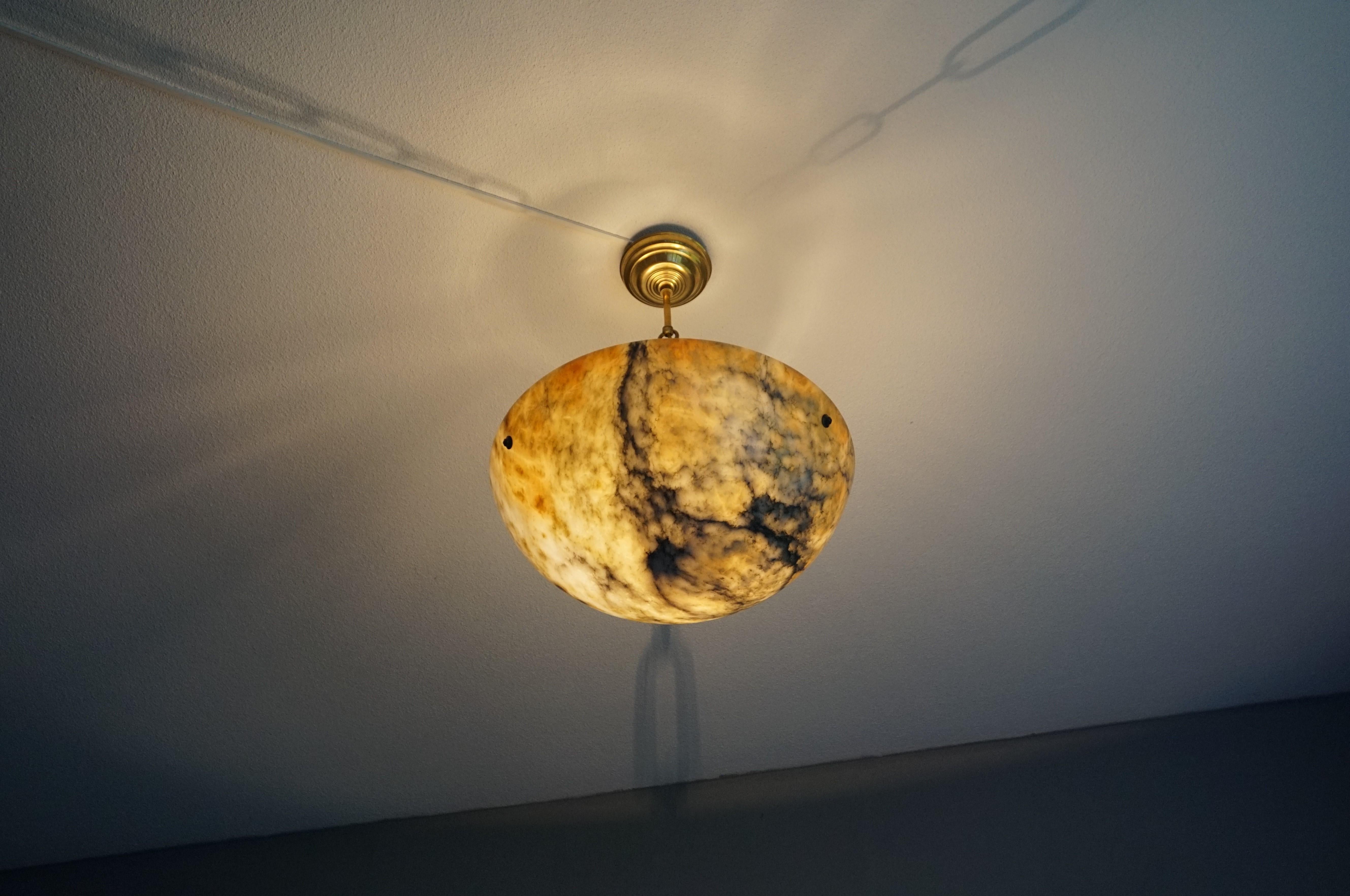 Impressive size, antique alabaster chandelier with amber colored patches.

One of the qualities of alabaster pendants is that no two shades will ever be exactly the same. Mother nature created this mineral stone over the course of many centuries and