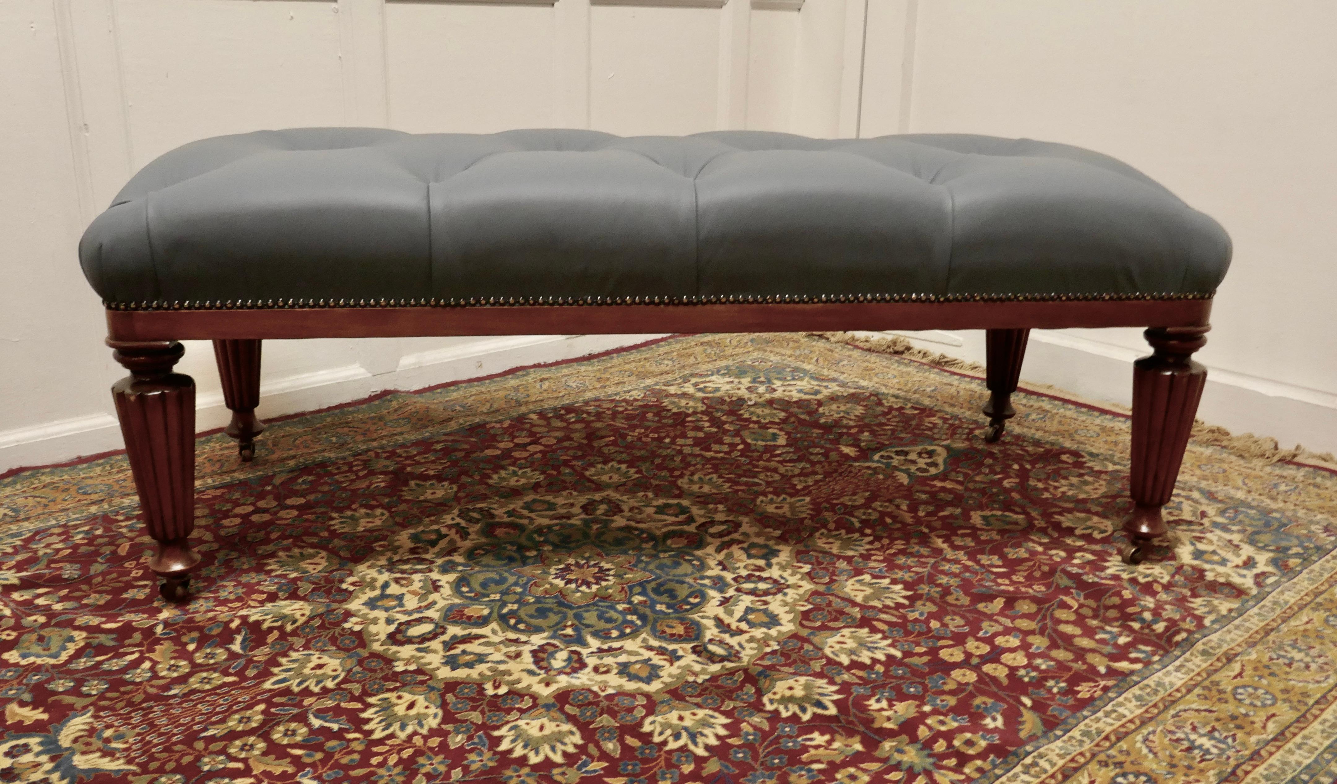 Large Deeply Buttoned Chesterfield leather Library Stool 

This is a good Sturdy Library Stool it has turned and fluted mahogany legs with brass casters 
The stool is newly upholstered, studded and buttoned in superbly soft Dove Grey Leather