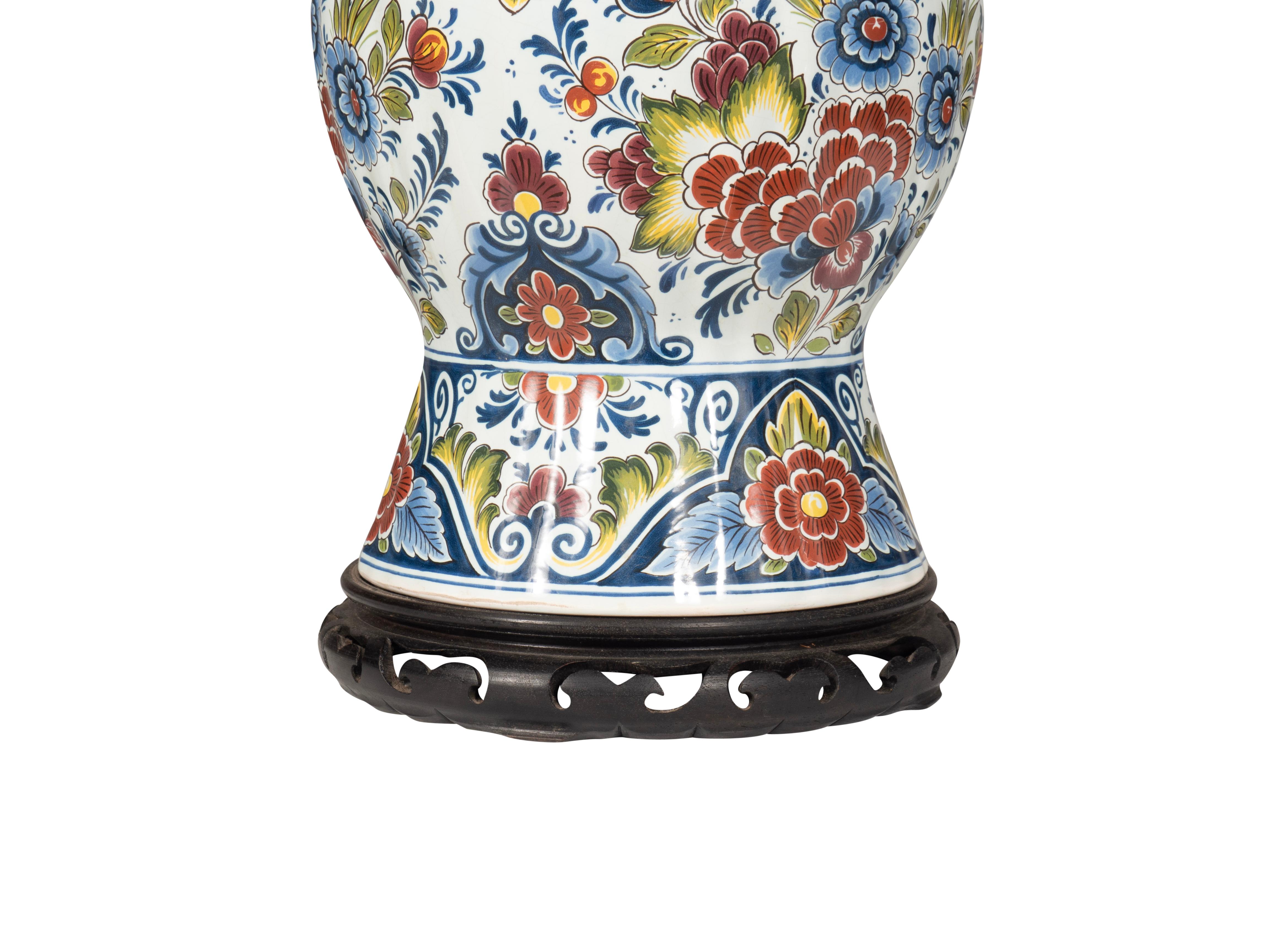 Large polychrome garlic neck vase mounted as a lamp. Single light. Hardwood base.