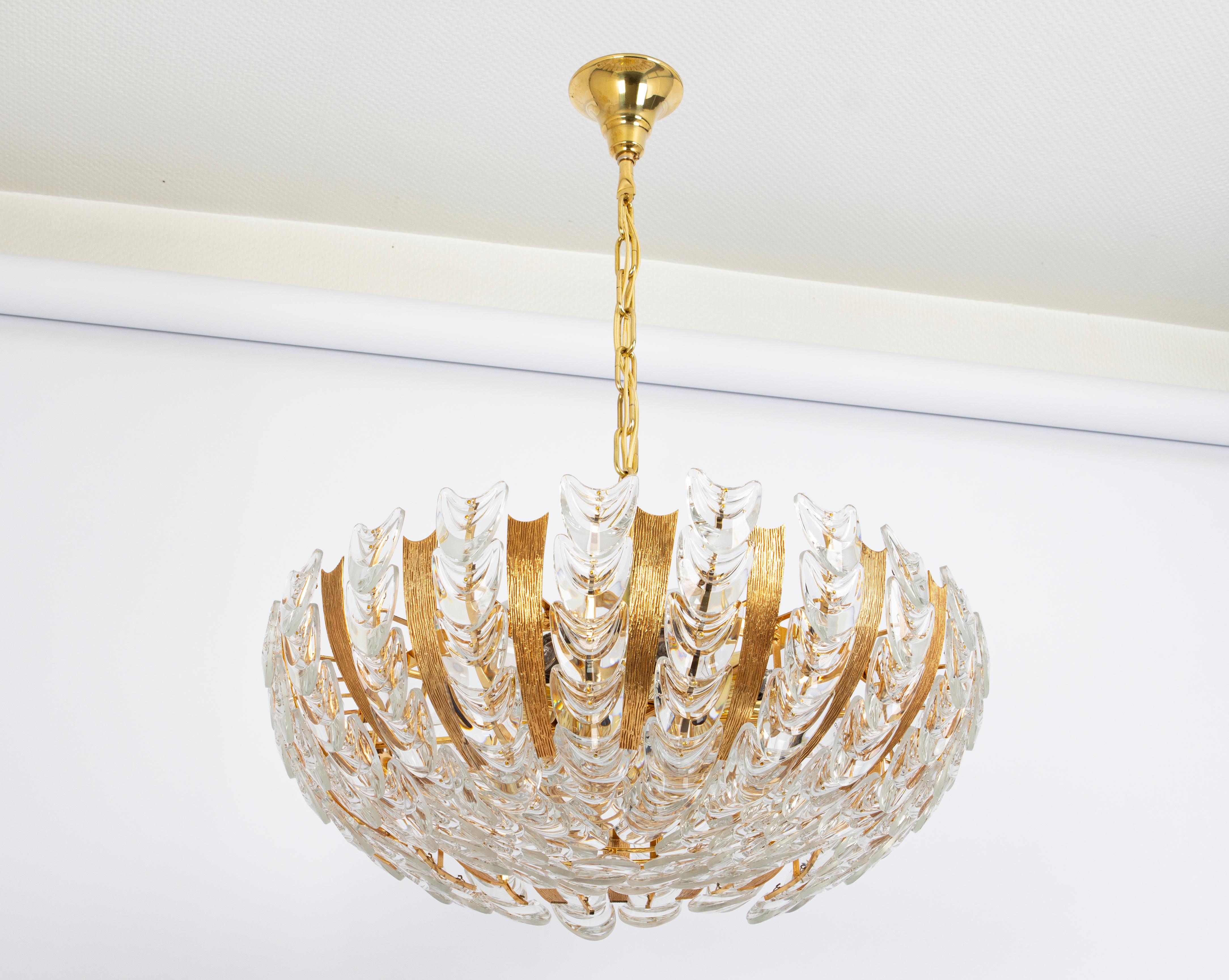 Large Delicate floral chandelier with crystal glass and gilded brass parts made by Palwa, Germany, 1970s. Featuring a multitude of crystal glass flowers.
Measures: Diameter 59 cm  // 23.6 inches
Sockets: 8 standard bulbs (E-27) max each 100W.
Light