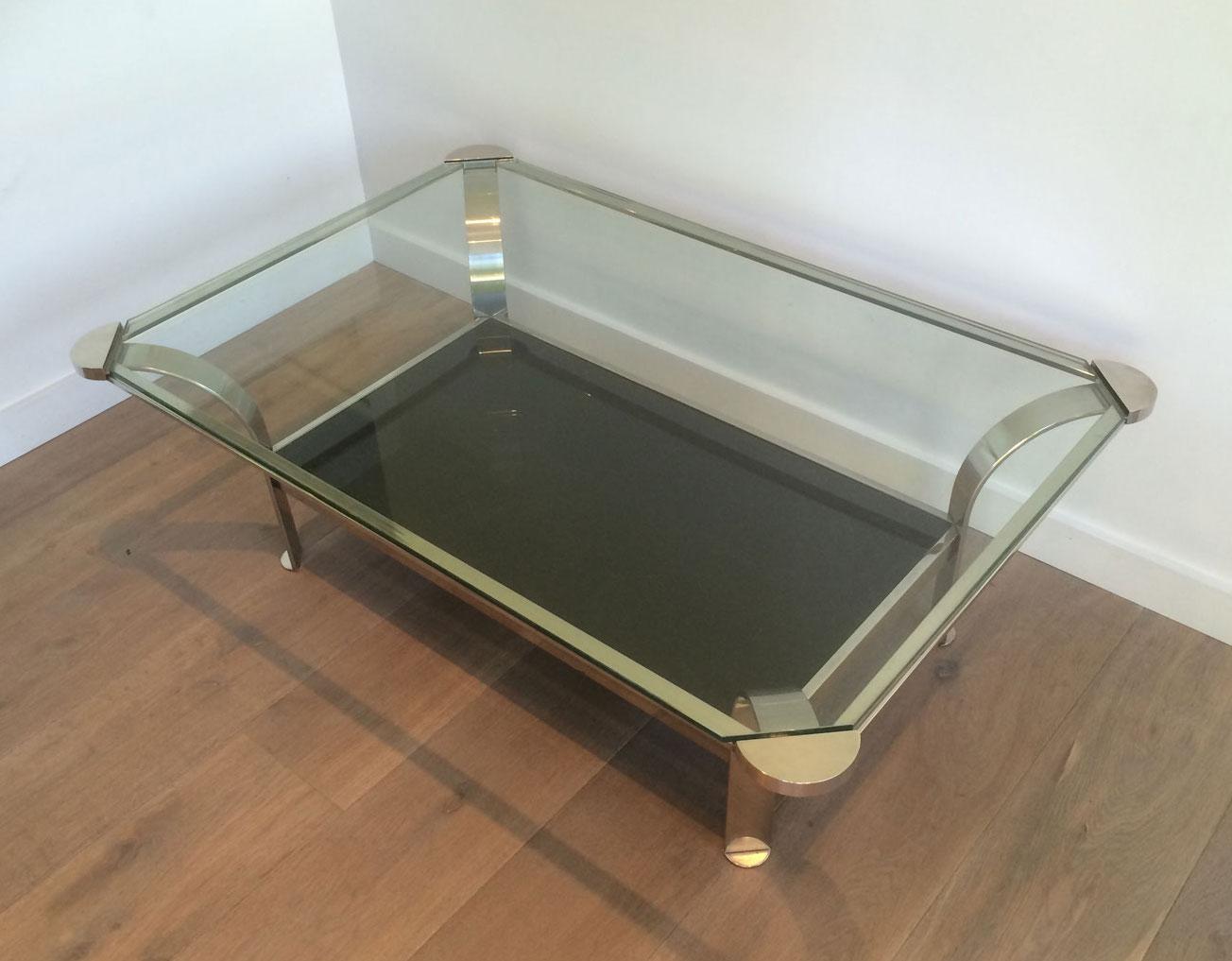 This large design chrome coffee table is made of chrome with clear glass shelf on top and black lacquered glass shelf on the bottom. This is a French work. Circa 1970