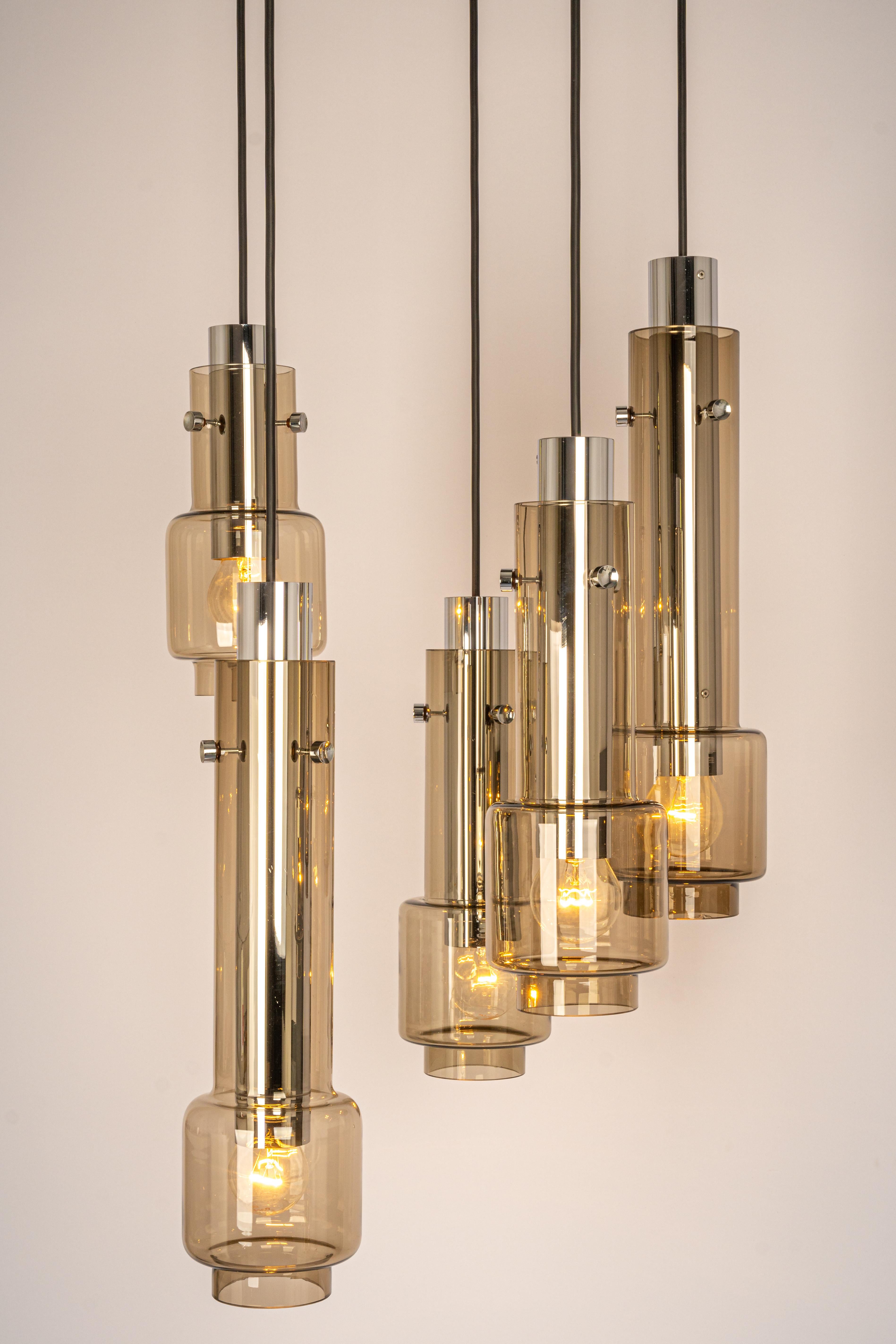 A special large cascading chandelier designed by Ott International Leuchten, manufactured in Germany, circa the 1970s with 5 smoked glasses on a chrome frame
Wonderful form and stunning light effect.
Sockets: 5 x E27 standard bulbs. (80 W max for