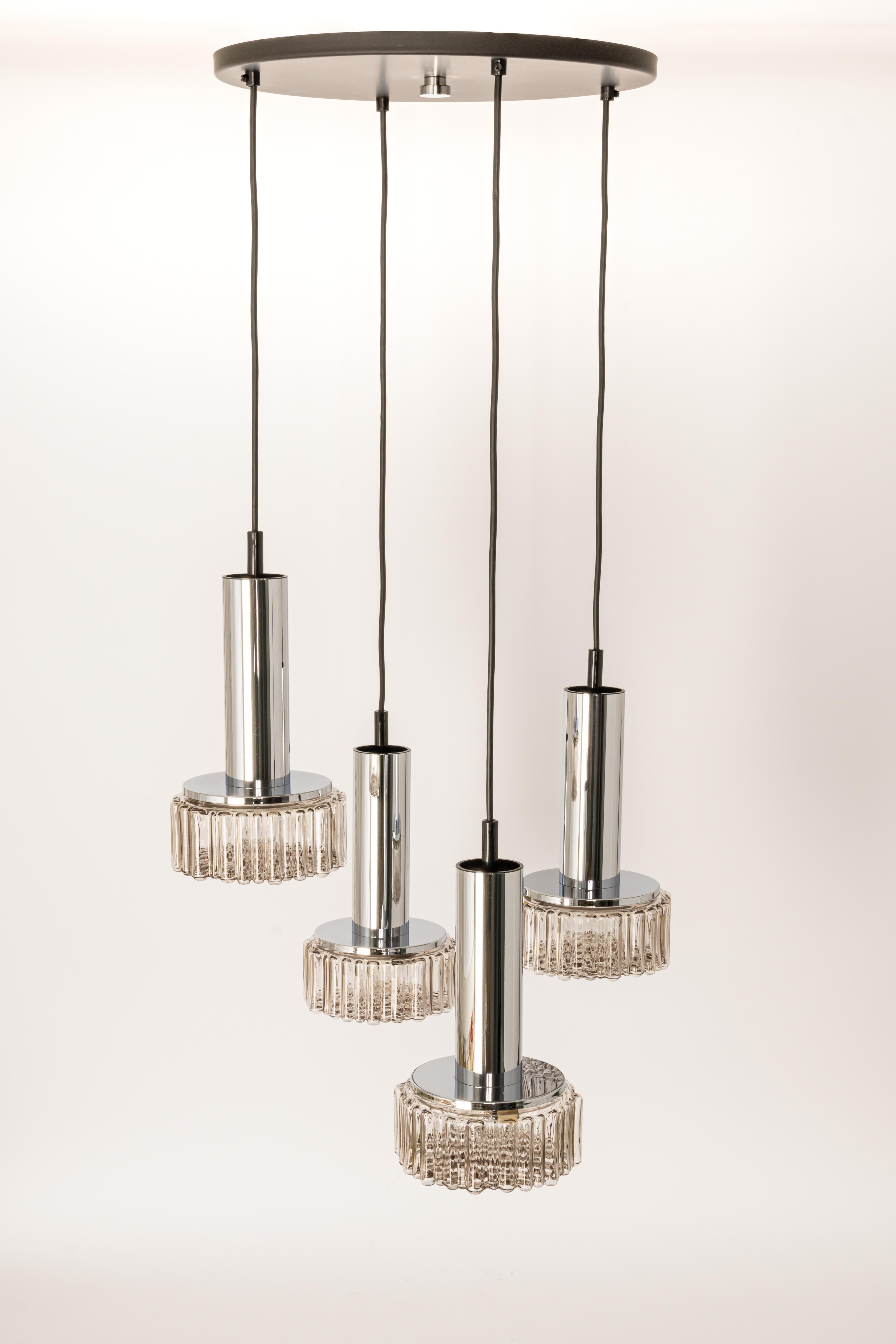 A special large cascading chandelier designed by Rolf Krüger for Staff Leuchten, manufactured in Germany, circa 1970s with 4 round bubble smoked glasses.
Wonderful form and stunning light effect.
Sockets: 4 x E26 /E27 standard bulb. (100 W
