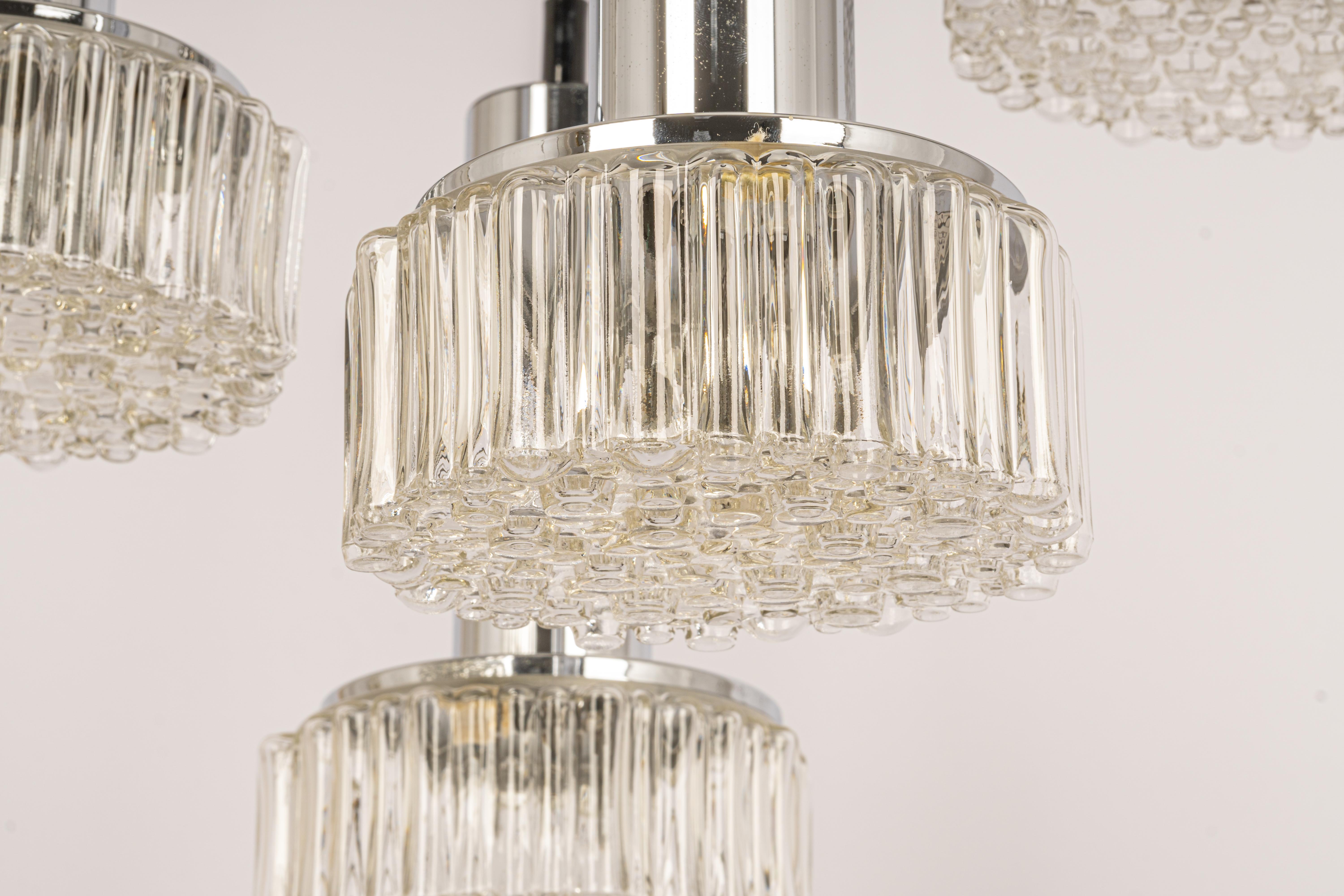 A special large cascading chandelier designed by Rolf Krüger for Staff Leuchten, manufactured in Germany, circa 1970s with 4 round bubble Clear glasses.
Wonderful form and stunning light effect.
Sockets: 4 x E26 /E27 standard bulb. (100 W