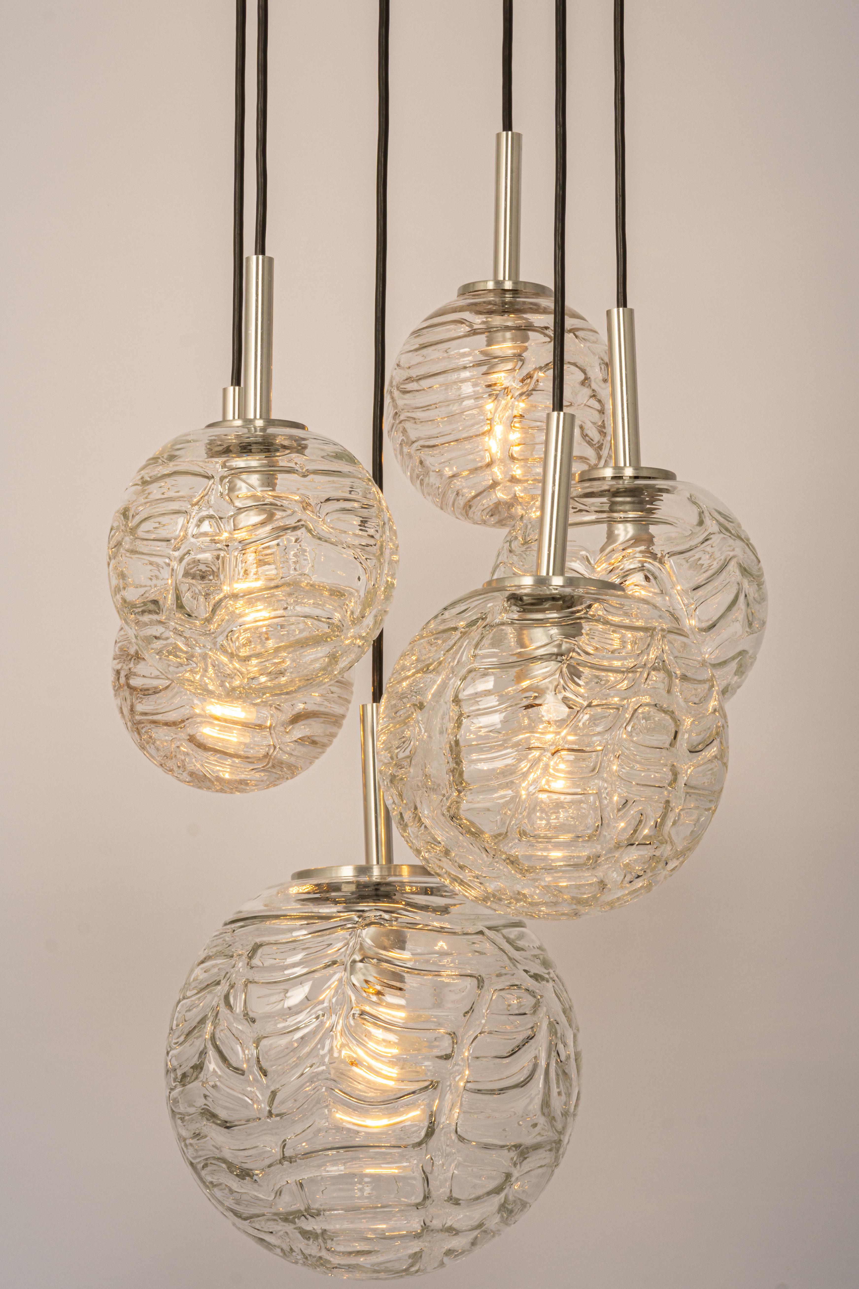 A special large cascading chandelier by Doria, manufactured in Germany, circa the 1970s with 6 Murano glasses.
Wonderful form and stunning light effect.
Sockets: 4 x E14 small bulb. (40 W max) and 2 X E27 Standard Bulbs ( up to 80 W each)
Light