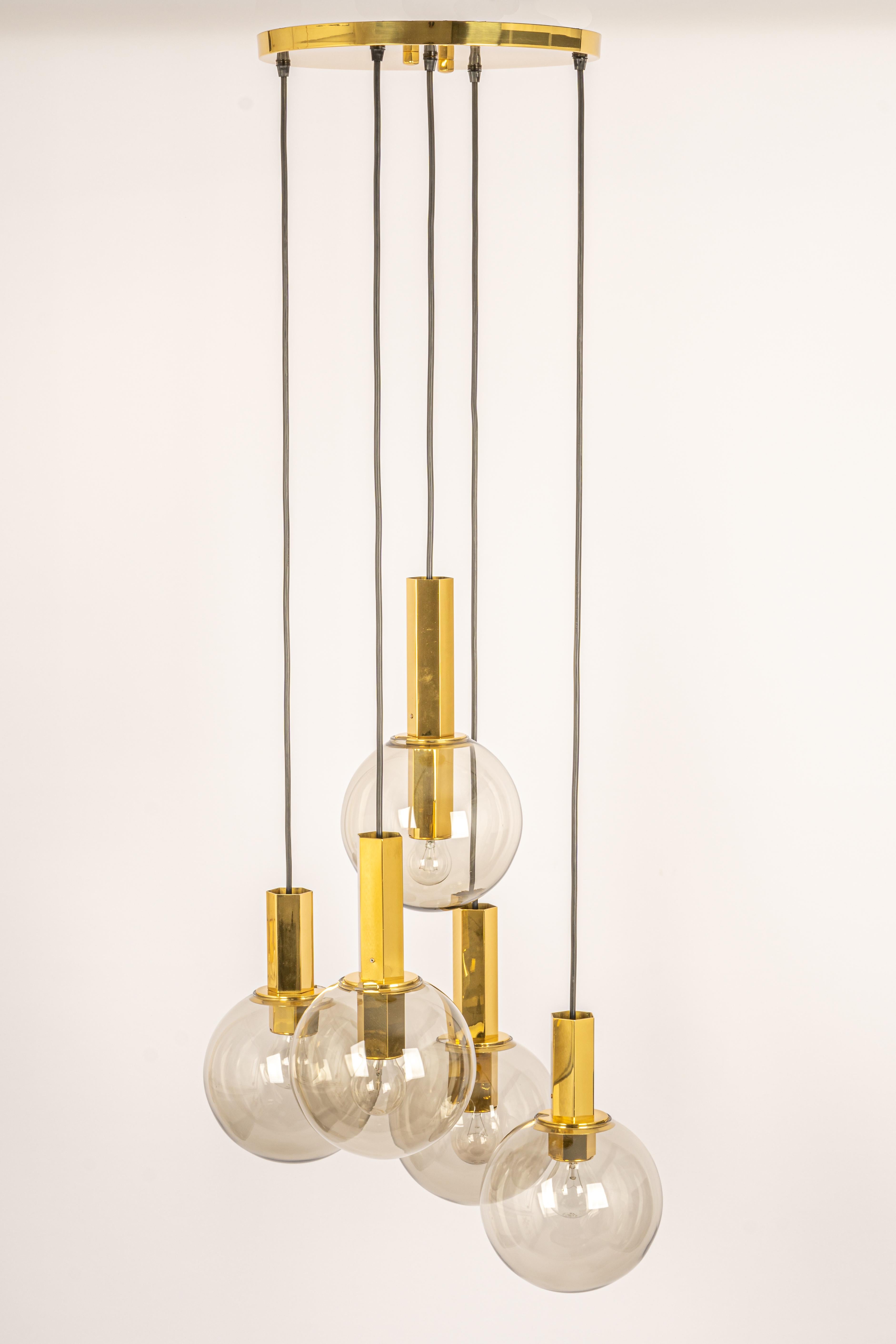 A special large cascading chandelier by Cosack, manufactured in Germany, circa the 1970s with 5 smoked glasses.
Wonderful form and stunning light effect.
Sockets: 5 x E27 standard bulb. (60 W max) 
Light bulbs are not included. It is possible to