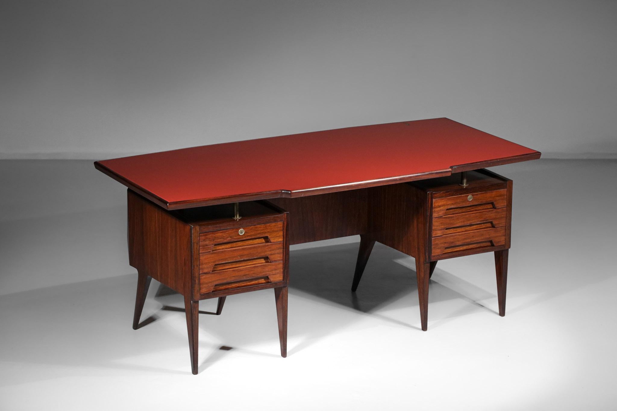 Large desk from the 1950s by Italian designer Vittorio Dassi. Solid and veneered wood structure, red glass top. The desk is composed of six deep drawers divided in two boxes. Very original desk with its 