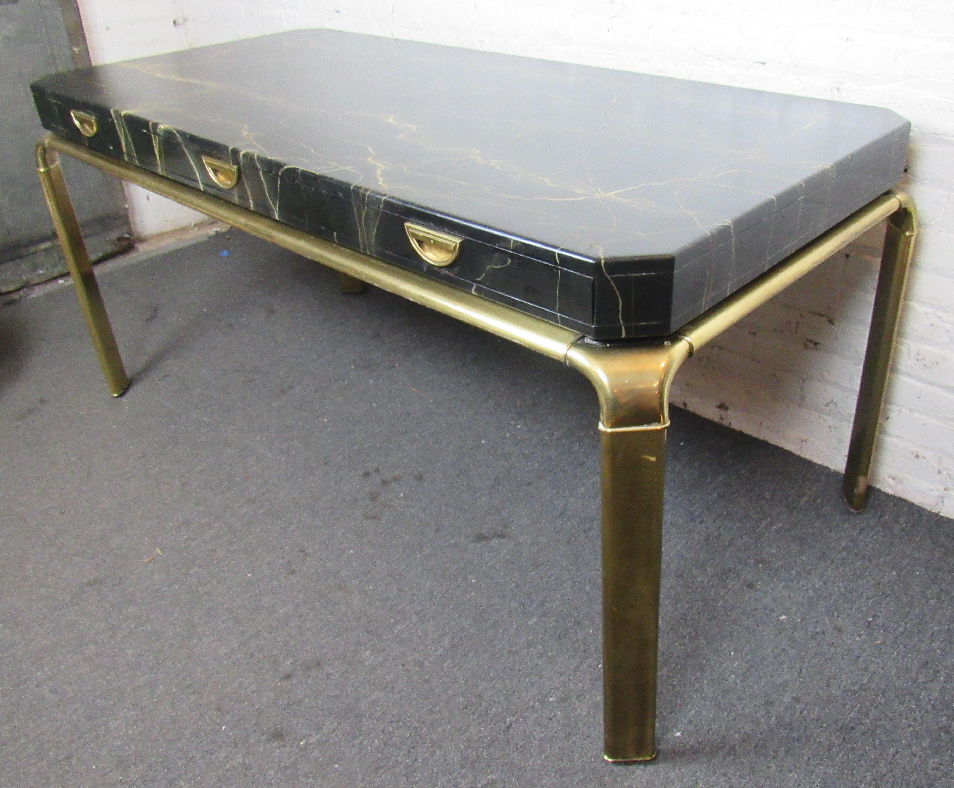Gorgeous executive desk built by Mastercraft for John Widdicomb Furniture.  A gold abstract splatter over an ebonized lacquered top helps the brass legs stand out in any room. Please confirm item pickup location (Brooklyn or NJ) with seller.