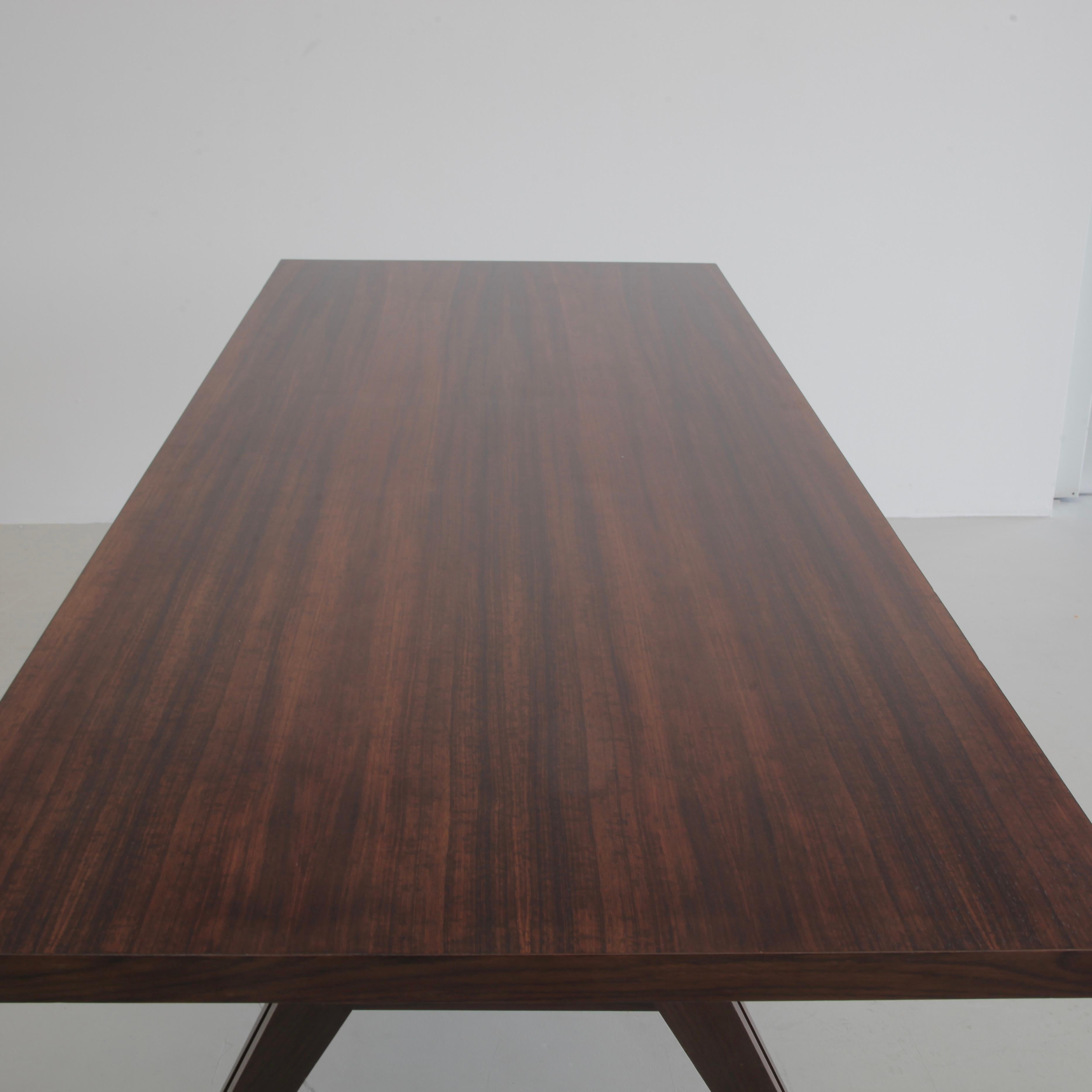 Table 'Tolomeo' designed by Ennio Fazioli. Italy, MIM Roma, 1963.

Teak table/ desk design by Fazioli with elegant dark wood grain top and three slim wooden drawers which can be accessed from one side (these can be removed). Solid wood U-shaped legs