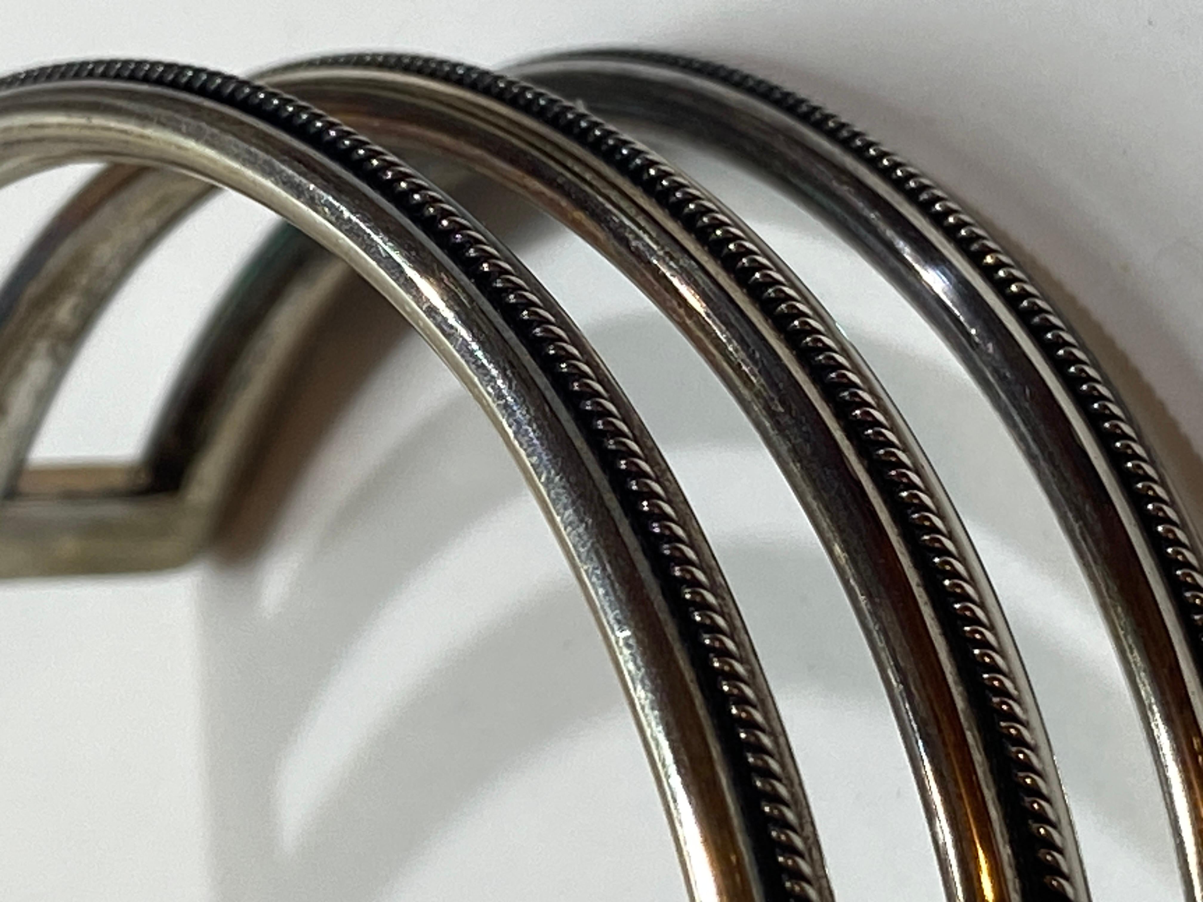 Wonderfully detailed three-band sterling silver cuff has a micro 