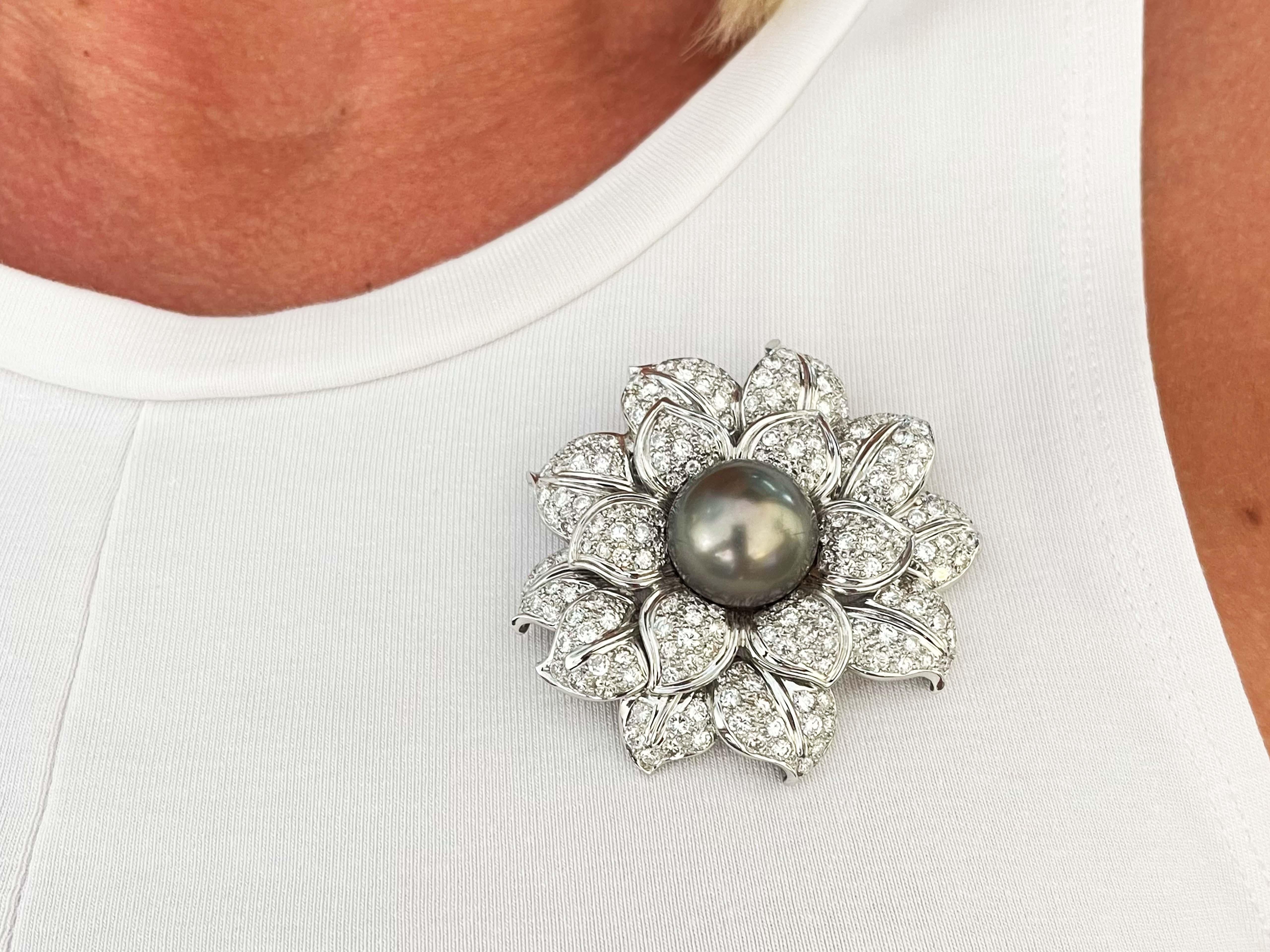 Item Specifications:

Style: Flower Brooch   

Metal: 18k White Gold

Diamond count: ~190

Diamond Shape: Round Brilliant

Diamond total carat weight: ~9.09

Diamond color: F-H

Diamond clarity: VS1-SI2

Pearl: Tahitian Pearl

Pearl Diameter: ~17
