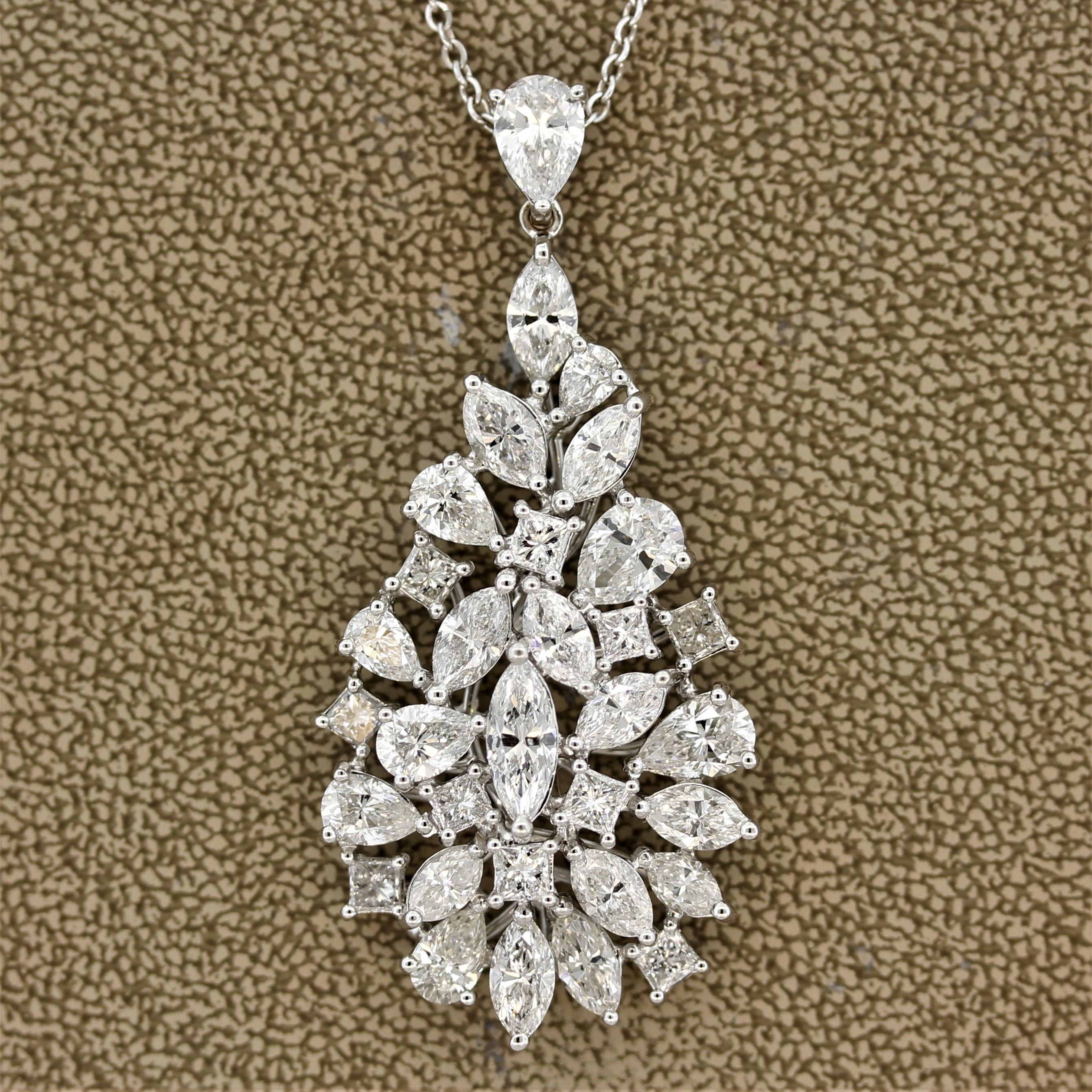 Not your average diamond pendant. This diamond cluster pendant features extra large diamonds of various shapes set in a clustered drop shape. The full-cut diamonds include marquise, pear, and radiant shapes with many of the diamonds weighing over a