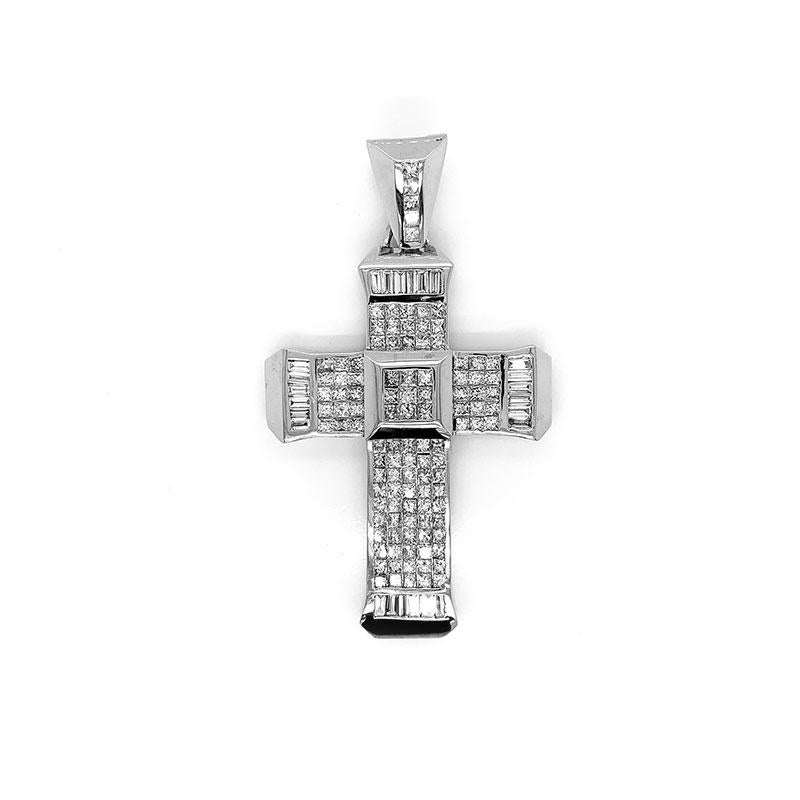 A massive cross pendant studded with fine diamonds. There are 10.7 carats of invisible set princess cut diamonds along with baguette cut diamonds which are channel set on the 4 ends of the cross. Made in 14k white gold and weighing over 1 ounce,