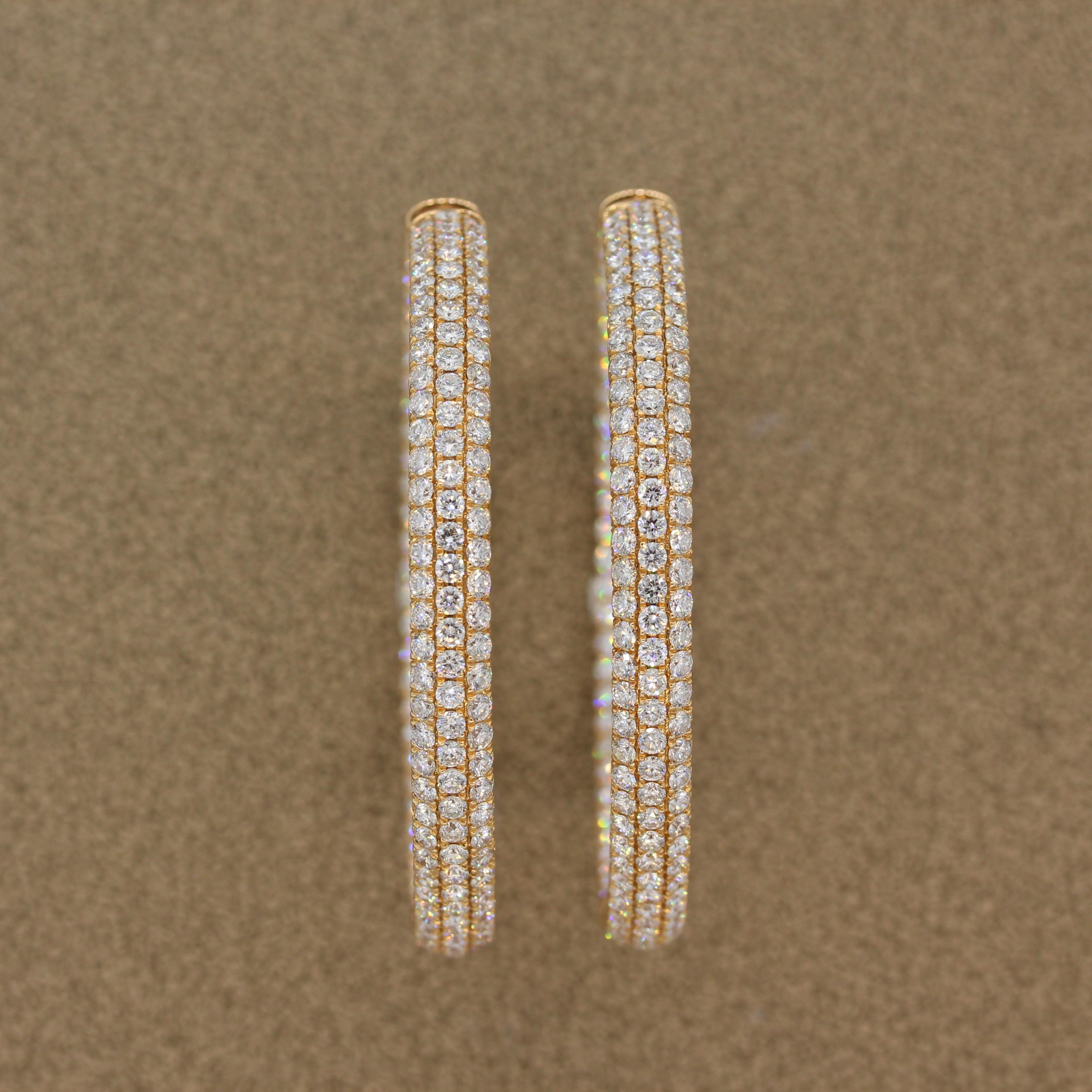 This pair of fun and glamorous inside-out hoop earrings features 14.36 carats of colorless VS quality diamonds. The round cut diamonds are pave set in these grand 18K rose gold earrings that will pair easily to any day and night outfit. A special