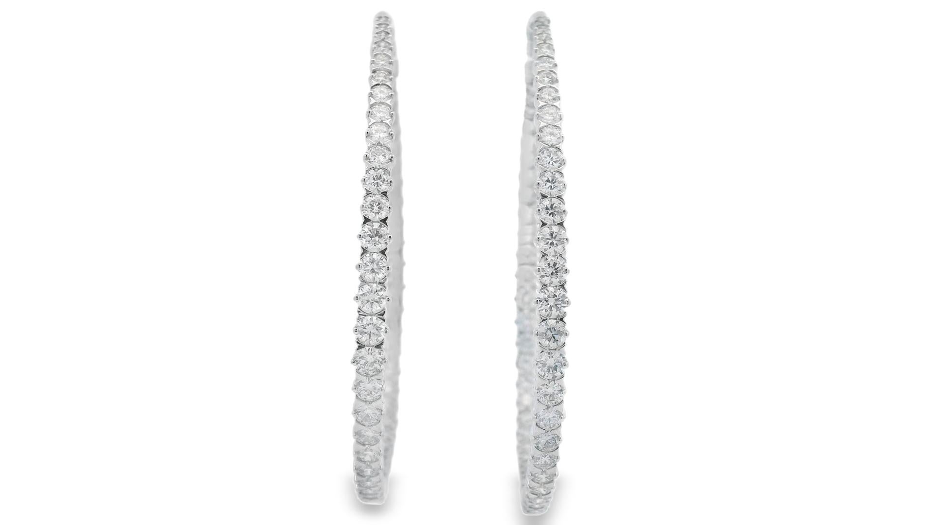 Lustrous and sophisticated, these extra-large diamond hoop earrings showcase 108 round brilliant-cut diamonds totaling 5.00 carats, set in gleaming 14K white gold. Each hoop features an inside-out design, ensuring diamond visibility from every angle