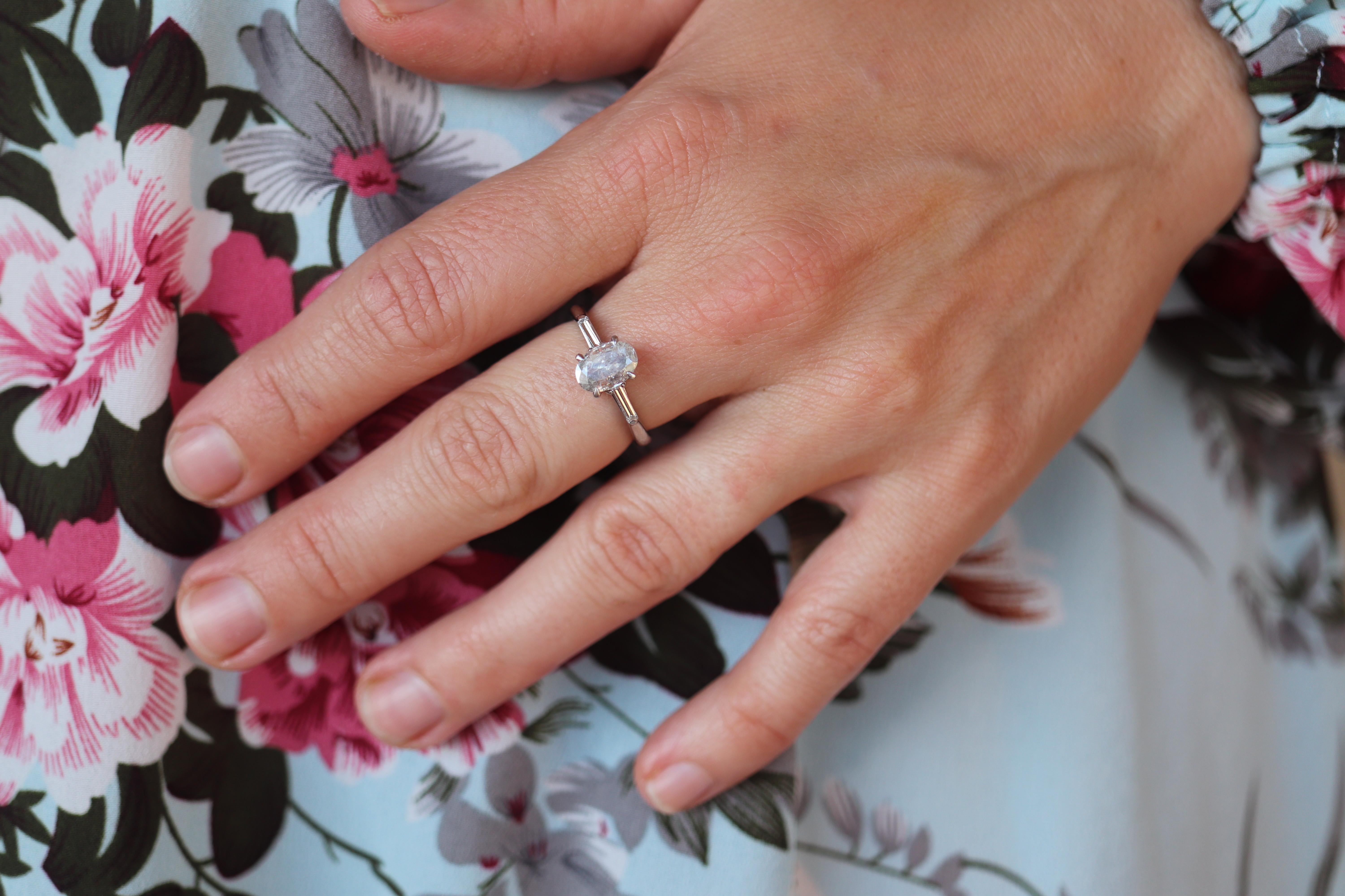 Stunning Diamond Solitaire.

1ct Oval Cut Natural Diamond
0.20 Tapered Baguette Diamond Accents

Pure Platinum Shank.

Appraised at $5450 replacement value. Appraisal is included.

Condition: Excellent Condition

Details:
I2 clarity Diamond with I