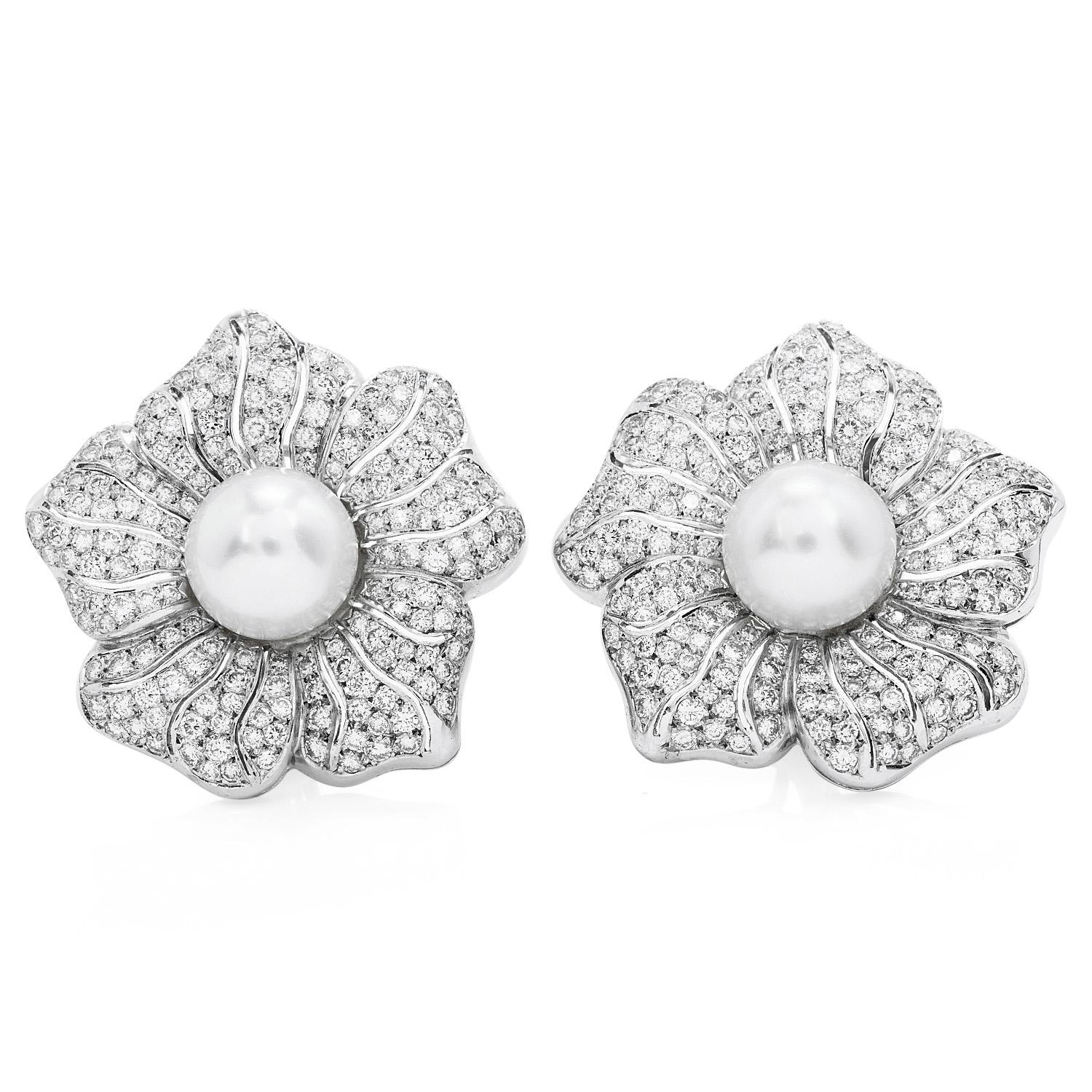 These are statement pieces for the empowered woman. Crafted in solid platinum, centered with two 12.5 mm South pearls, high luster & pinkish silver undertones.  flanked by a cluster of round-cut diamonds weighing approx. 10.30 carats, graded
