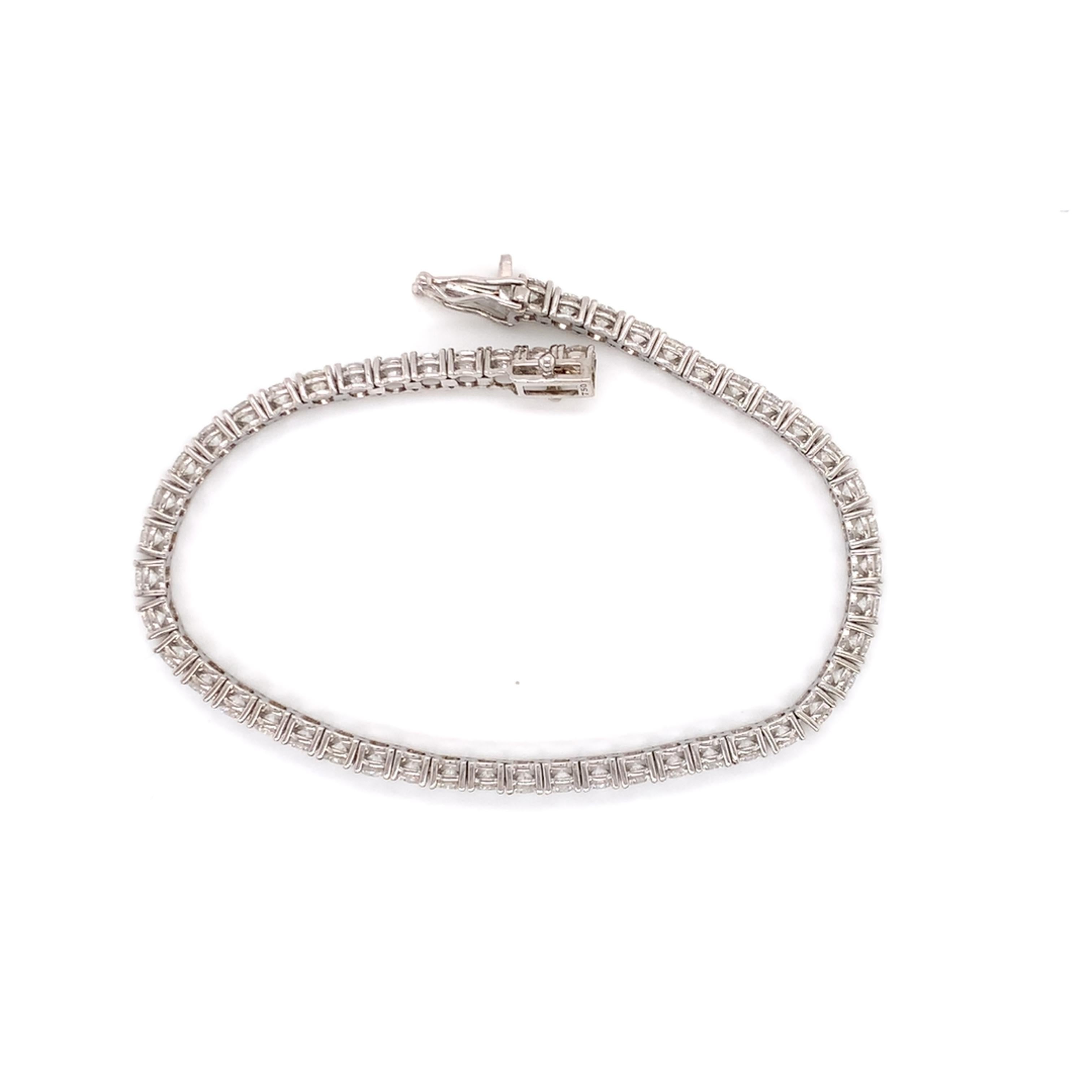 Large diamond tennis/line bracelet made with real/natural brilliant cut diamonds. Total Diamond Weight: 6.74 carats. Diamond Quantity: 52 round diamonds. Mounted on 18 karat white gold setting.