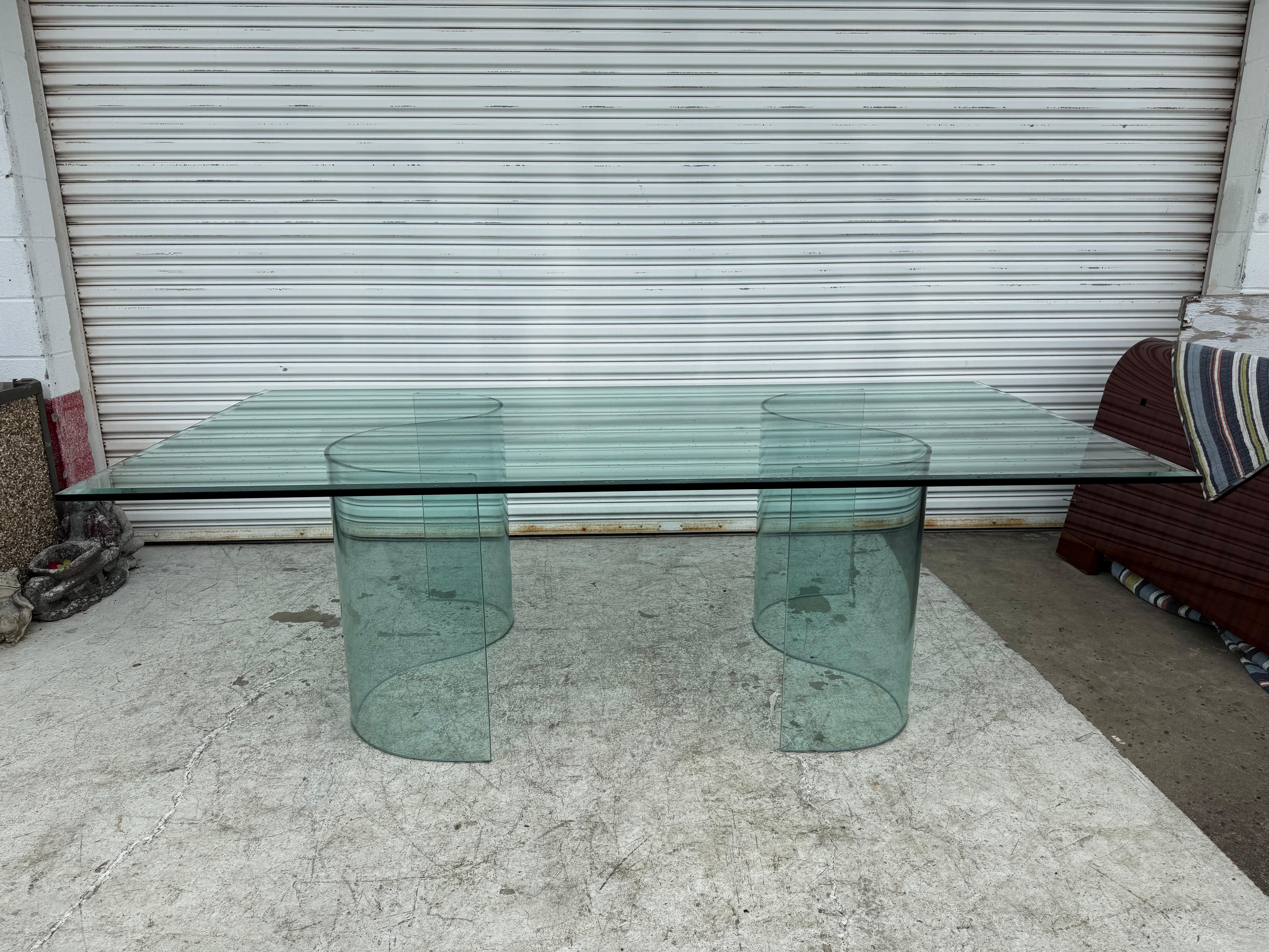 Large glass top, Modern, all-transparent design conference or dining table attributed to Fiam Italia. It features a sturdy, thick ¾” glass top with 1 ½” beveled ends and a pair of modern glass wave-shaped pedestal bases. This table blends equally