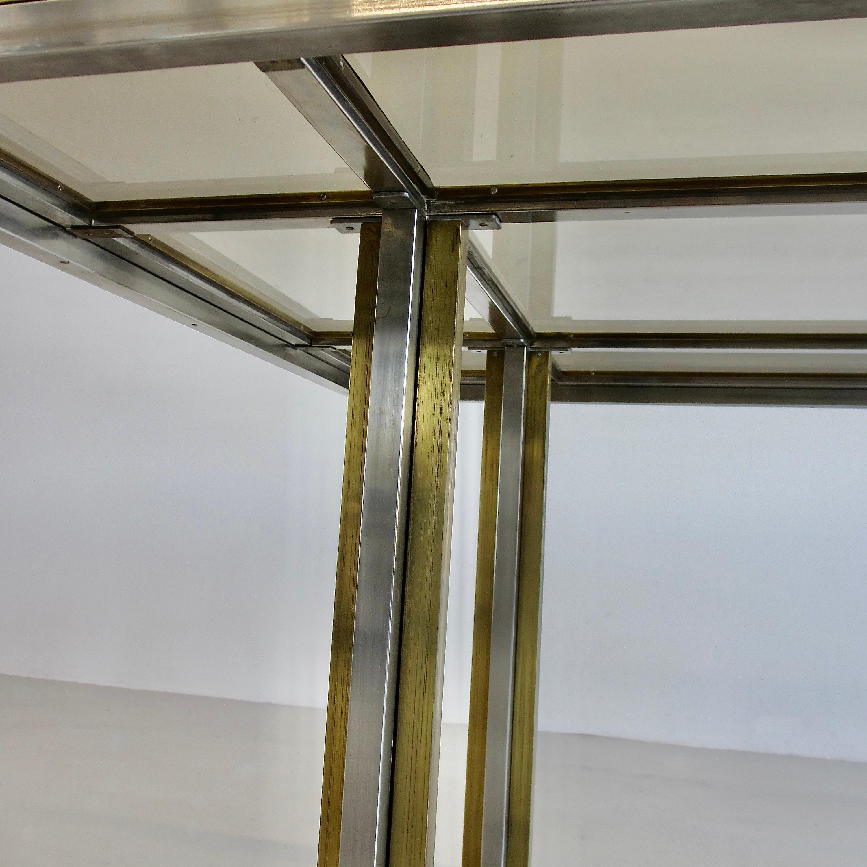 Dining table, designed by Romeo Rega. France, Metalarte, c1975.

A large dining table in brass and chromed metal feet and structure with nine separate smoked glass panel inserts. Beautiful elegant design by Rega.
Condition:  

Vintage