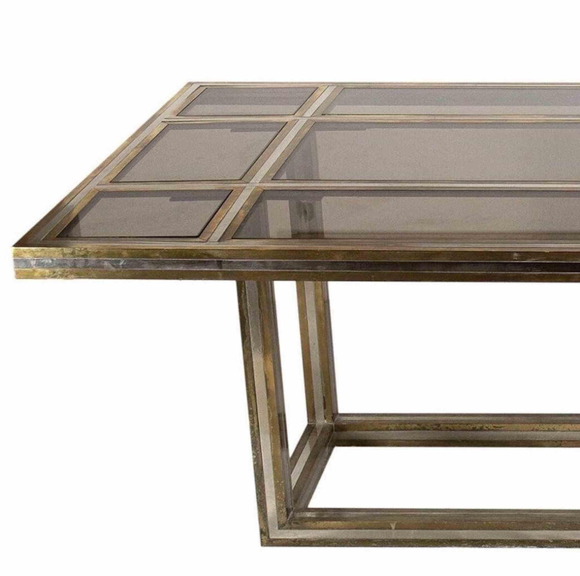 A majestic and elegant large dining table by the Italian designer Romeo Rega.

Rectangular table with brass and steel frame. Top in brass and steel and smoked crystal.

Work accompanied by a certificate of authenticity from the Rega