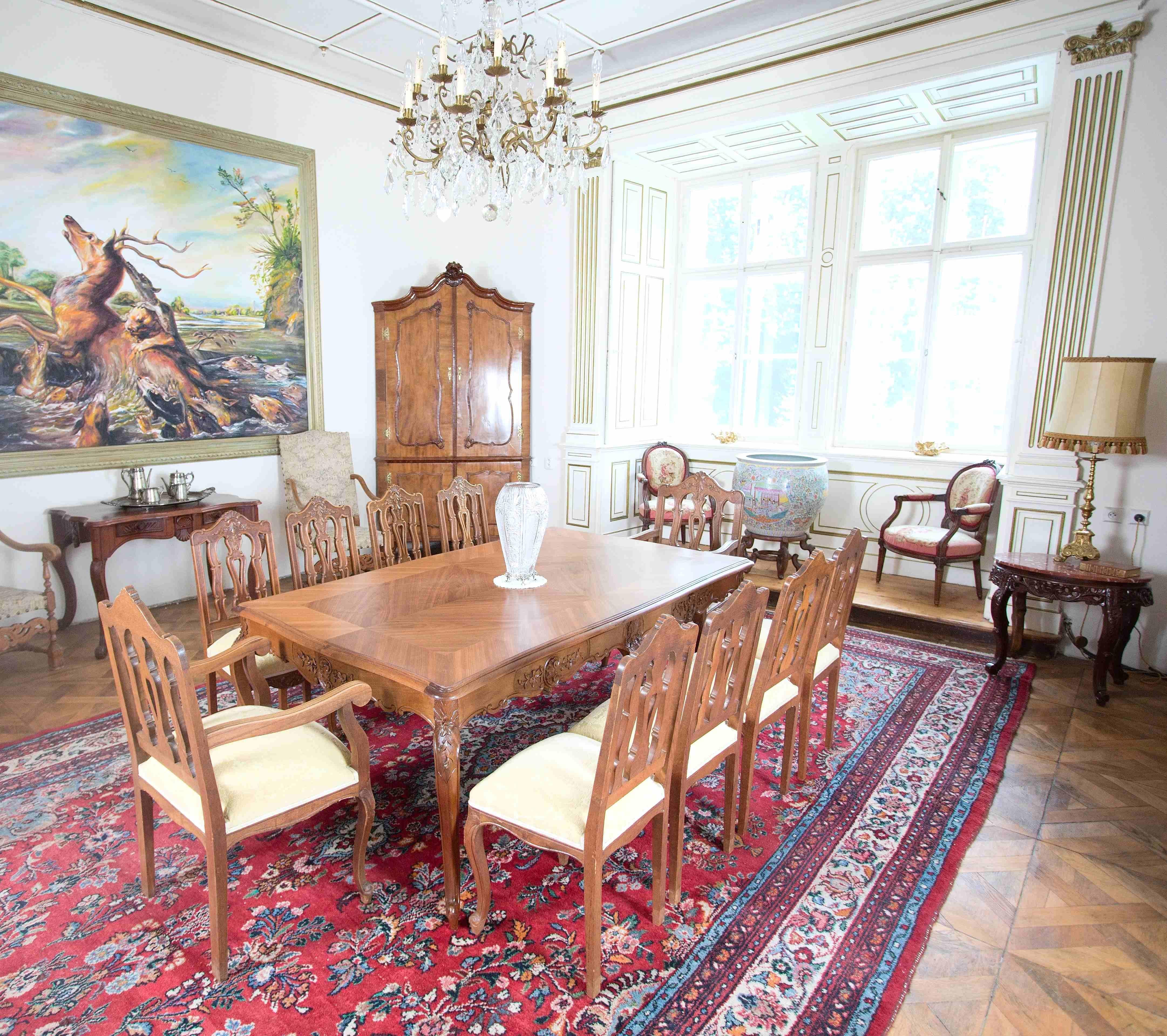 A spacious dining table in the rococo style of Louis XV. The top plate is decorated with mirror-folded veneer, rich profiling of the edges with massive veneers. The base of the table consists of six 