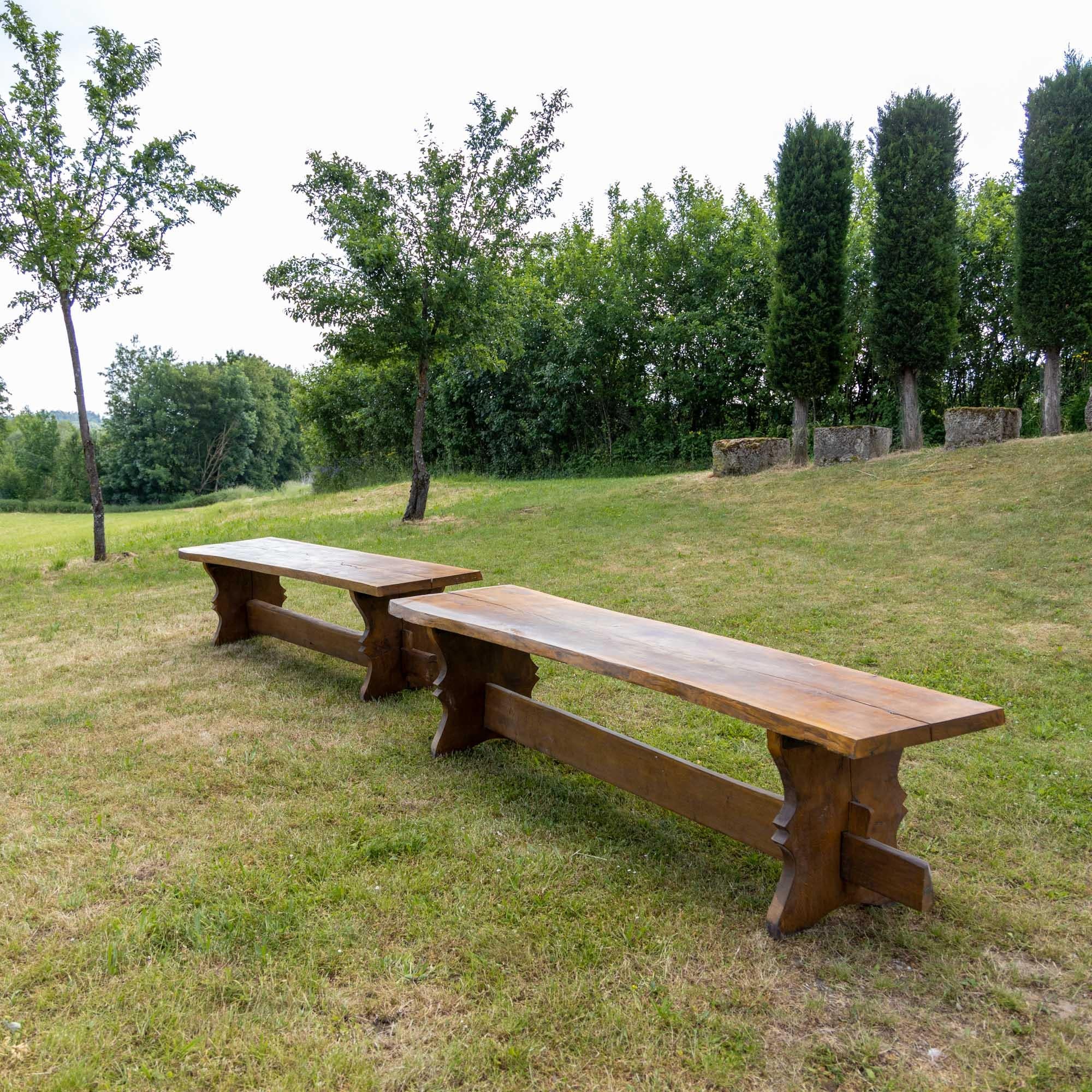 Two large dining tables made of solid oak with cut-out side pieces and central bar. The table top is cut from one continuous piece of wood. Rustic, authentic condition.