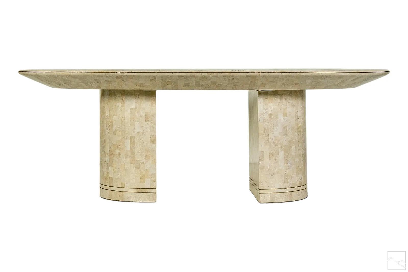 A glamorous dining table designed and retailed by Karl Springer, circa 1980s. The iconic shape features a beveled horse track-shape top with rounded corners is supported by two demilune pedestal bases attached with screws and built-in steel plate