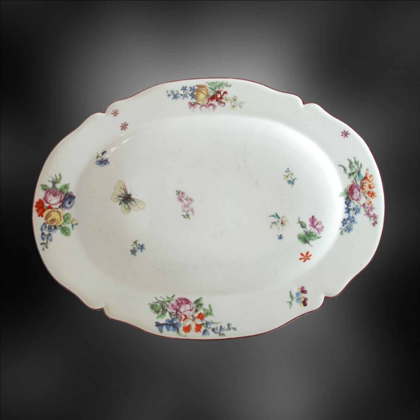A large platter, probably once associated with tureen. Beautiful flower painting, possible done outside the factory at the Giles studio in London, or perhaps at the Chelsea studio by a painter who had previously worked there. The tulip, heartease,