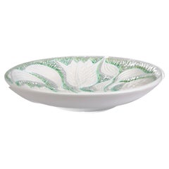 Large dish decorated with serpentine flowers and glazed in white and light green