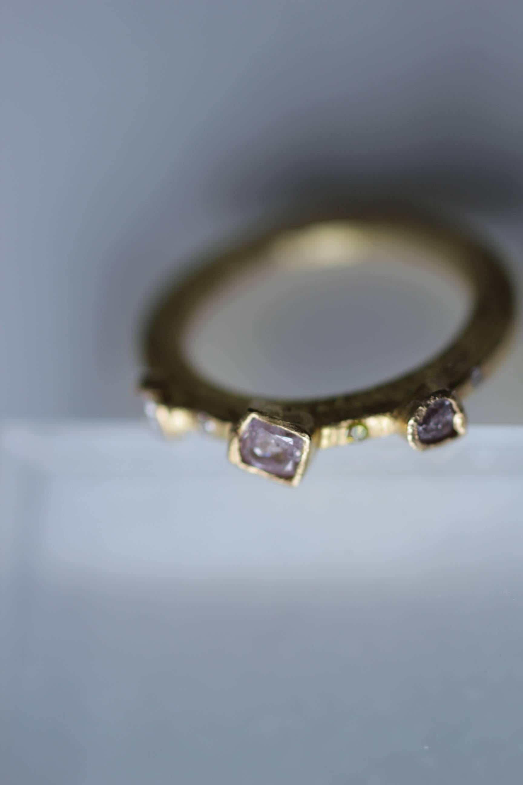 Custom listing. Handmade engagement bridal ring with three-stone bezel-set pink diamonds in 22K recycled gold and four flush-set diamonds. 

Custom order. This striking three-stone engagement ring can be ordered in any size. Made of recycled 22k