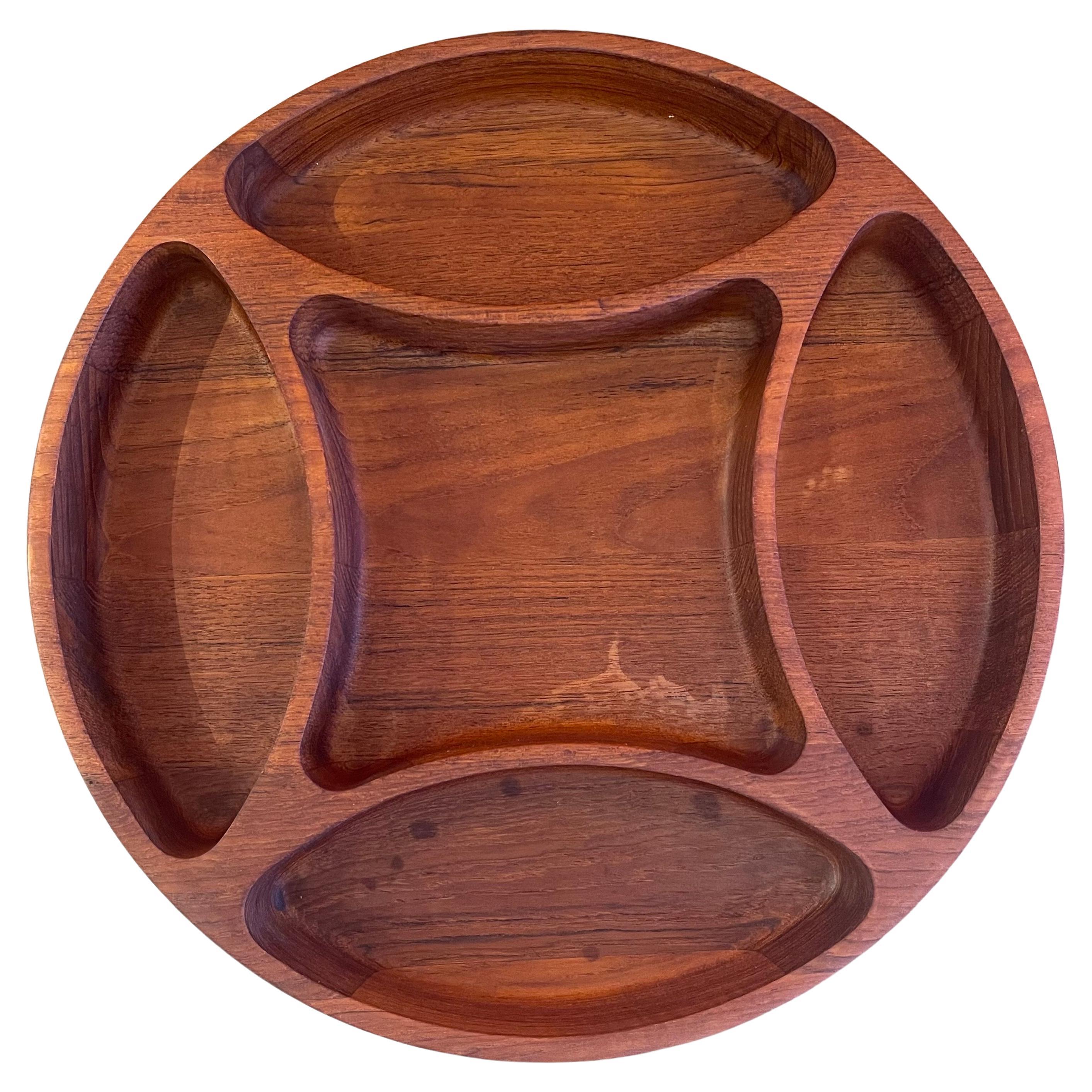 A large divided bowl / tray in teak by Jens Quistgaard for Dansk, circa 1960s. The tray is quite functional with five different walled sections and is in very good vintage condition. The piece measures 14.75