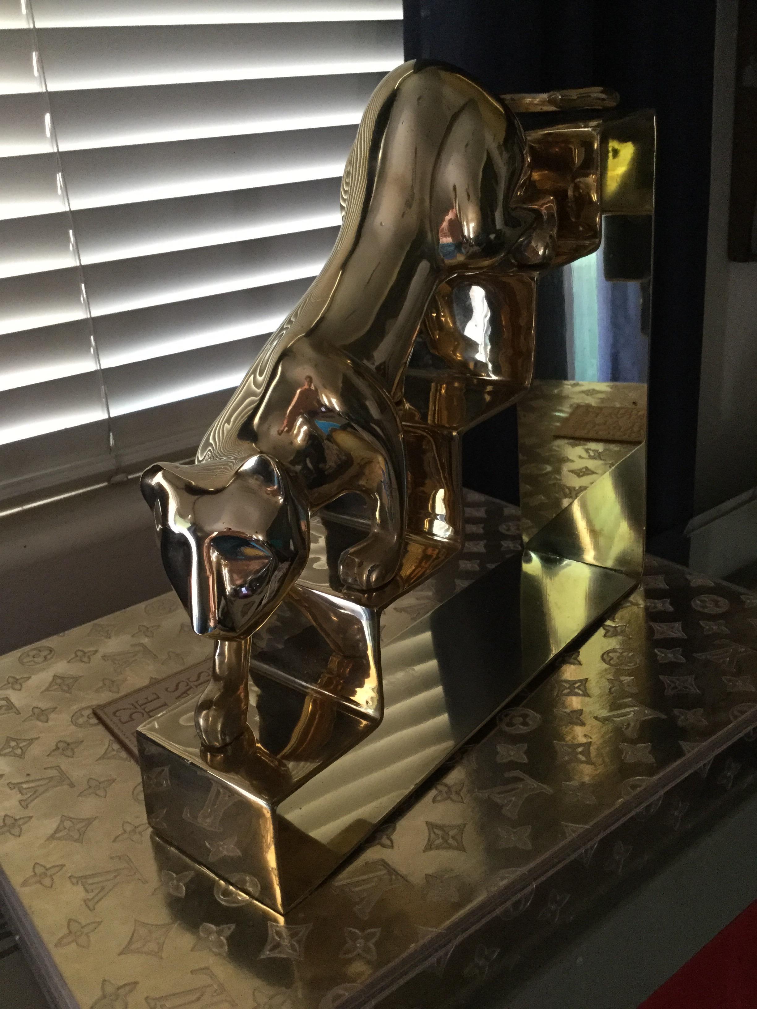 This is a real beauty and rare Dolbi brass piece. Large panther on stairs. Done in a Art Deco / Moderne style. Newly polished.