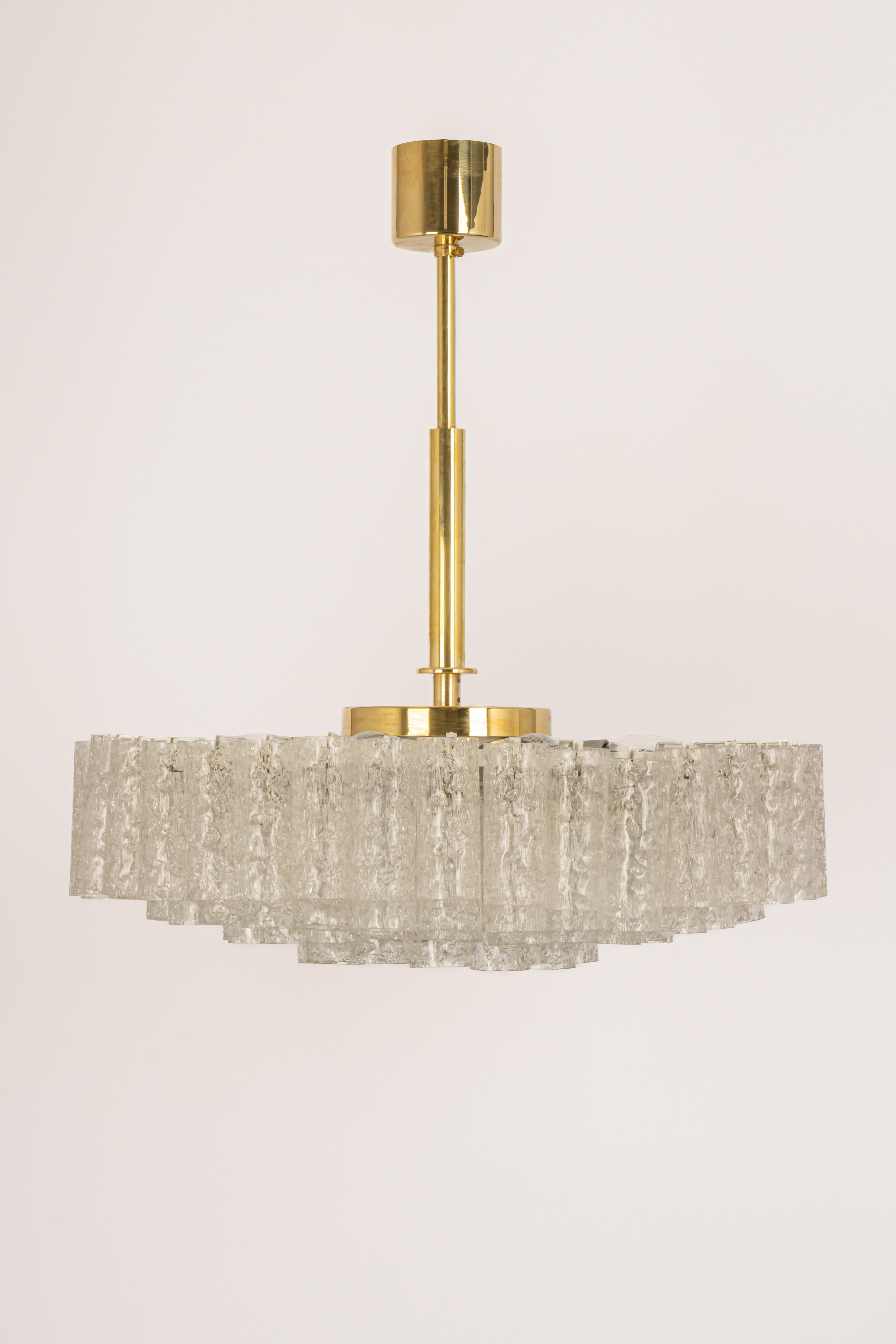 Fantastic four-tier midcentury chandelier by Doria, Germany, manufactured circa 1960-1969. 4 rings of Murano glass cylinders suspended from a fixture.

Sockets: 9 x E14 candelabra bulbs (up to 40 W each) .
Light bulbs are not included. It is