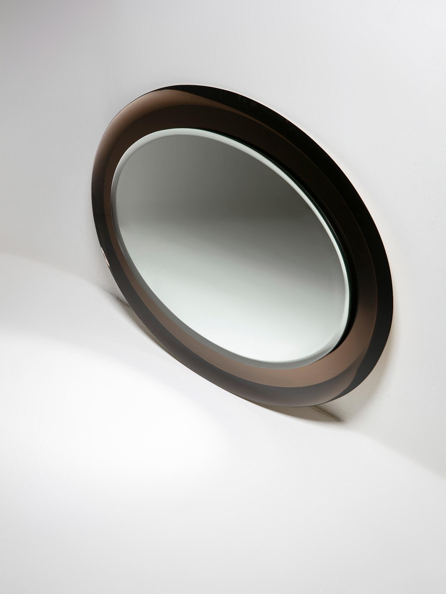 Miroir ovale doublement biseauté de Metalvetro, Sienne.
Le cadre marron frais et décoloré soutient la pièce centrale.
Label original en papier au verso